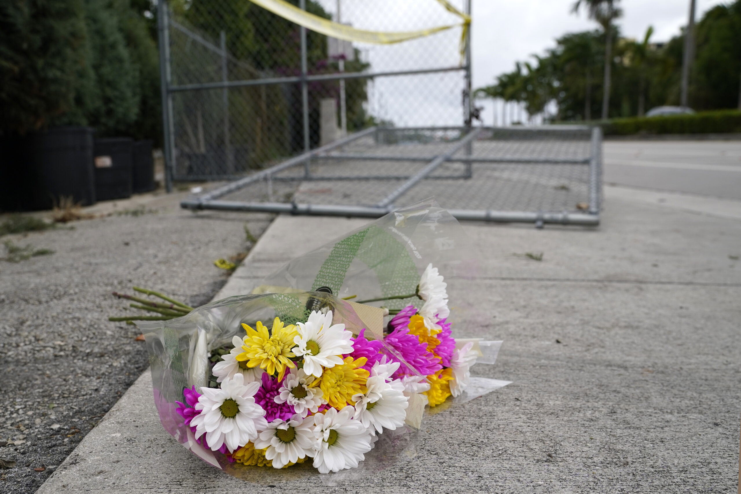 Flowers lie at the scene where a driver slammed into spectators at the start of a Pride parade Saturday evening, killing one man and seriously injuring another, Sunday, June 20, 2021, in Fort Lauderdale, Fla. Officials said the crash was an accident, but it initially drew speculation that it was a hate crime directed at the gay community. The driver and victims were all members of the Fort Lauderdale Gay Men's Chorus, who were participating in the Wilton Manors Stonewall Pride Parade. (AP Photo/Lynne Sladky)