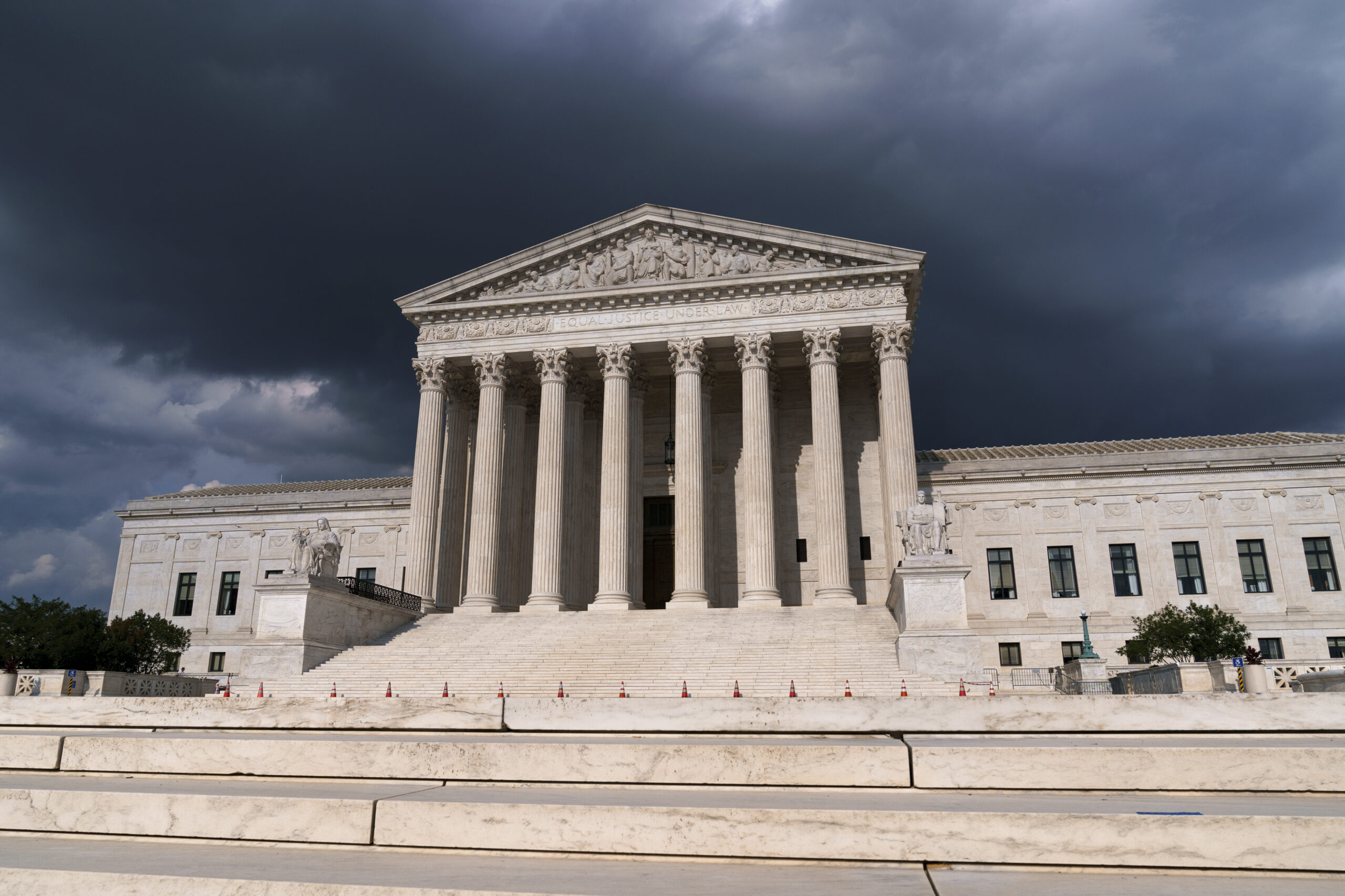 In this June 8, 2021 photo, with dark clouds overhead, the Supreme Court is seen in Washington. (AP Photo/J. Scott Applewhite)