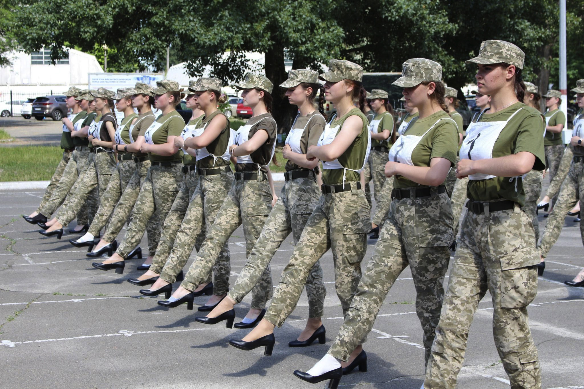 In this photo taken and released by the Ukrainian Defense ministry press-service on July 2, 2021, Ukrainian female soldiers wear heels while taking part in the the military parade rehearsal in Kyiv, Ukraine. Ukraine's defense minister is under pressure from members of the government over the decision to have female military cadets wear mid-heeled pumps in a parade. A joint statement from three Cabinet members, including Minister of Veterans Affairs Yulia Laputina, said “the purpose of any military parade is to demonstrate the military ability of the army. (Ukrainian Defense Ministry Press Office via AP)