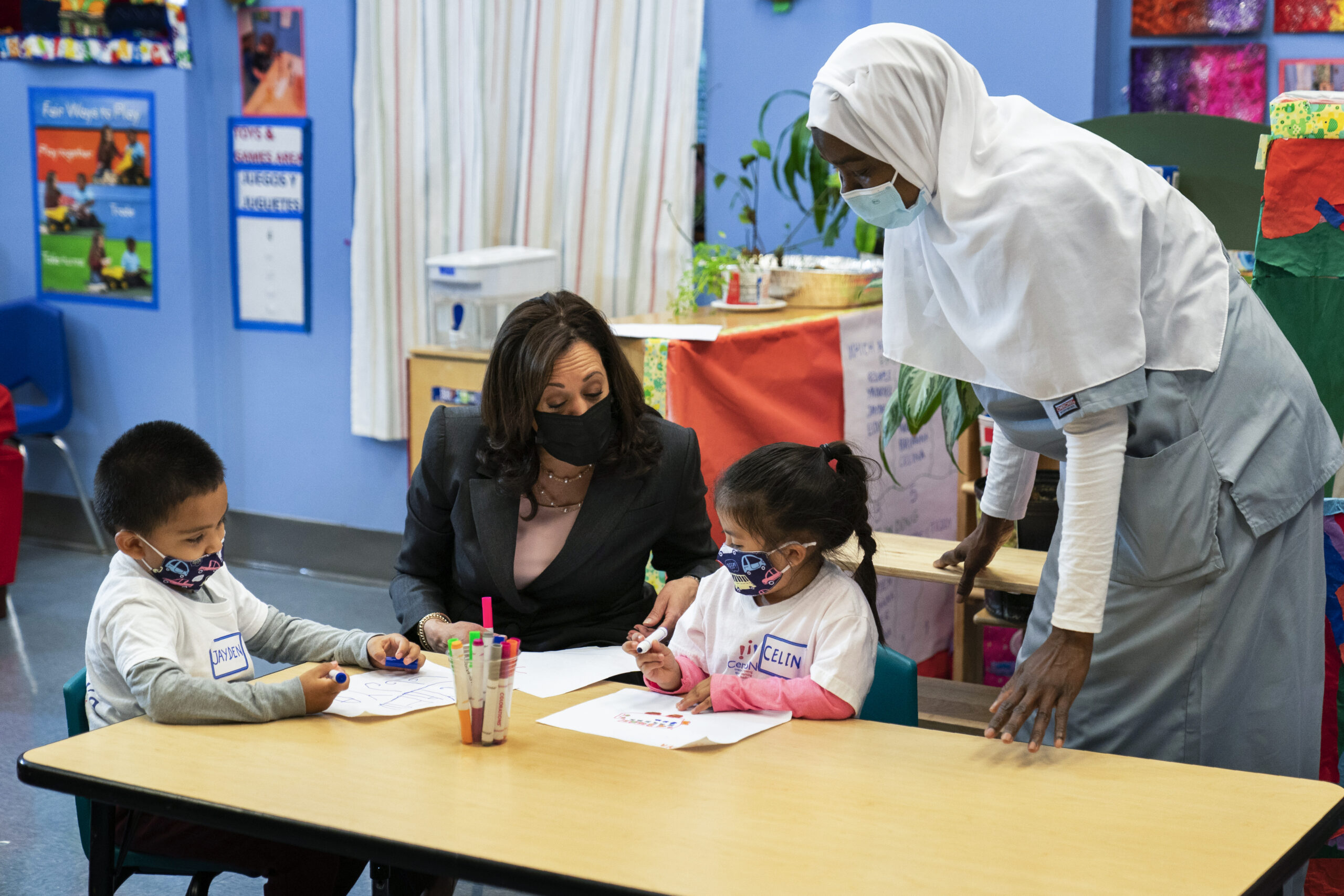 FILE - In this June 11, 2021, file photo, Vice President Kamala Harris talks with bilingual early childhood education school CentroNia students Jayden Bello, left, and Celina Barrera during a visit to the school in northwest Washington. Teacher Billo Diawara, right, watches. (AP Photo/Manuel Balce Ceneta, File)