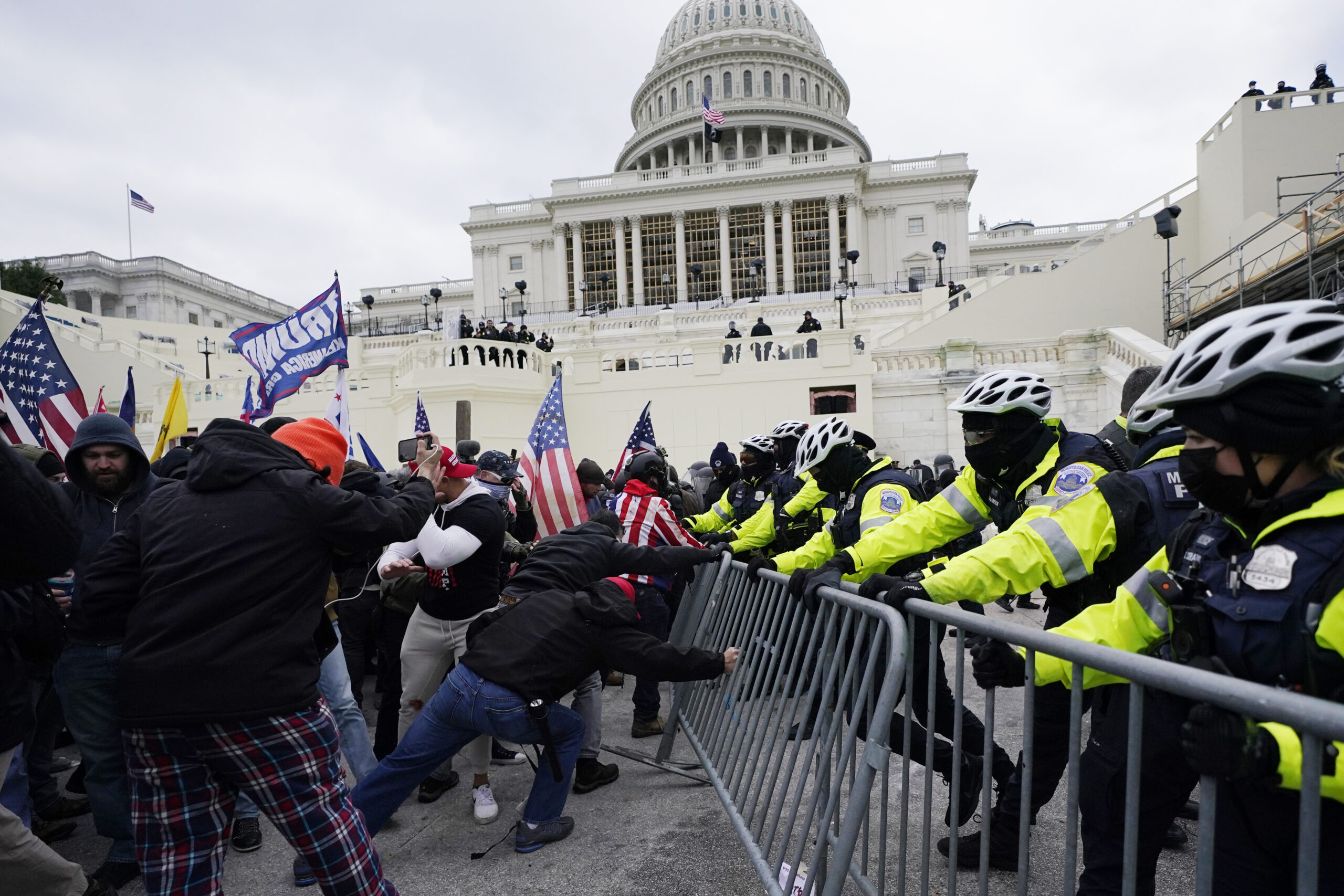 FILE - In this Jan. 6, 2021 file photo, supporters loyal to then-President Donald Trump, try to break through a police barrier at the Capitol in Washington. Key figures in the Jan. 6 riot on U.S. Capitol spoke about their desire to overthrow the government, but to date, U.S prosecutors have charged no one with sedition. They could still add them. But prosecutors may be reluctant to bring them because of their legal complexity and the difficulty in securing convictions. (AP Photo/Julio Cortez)
