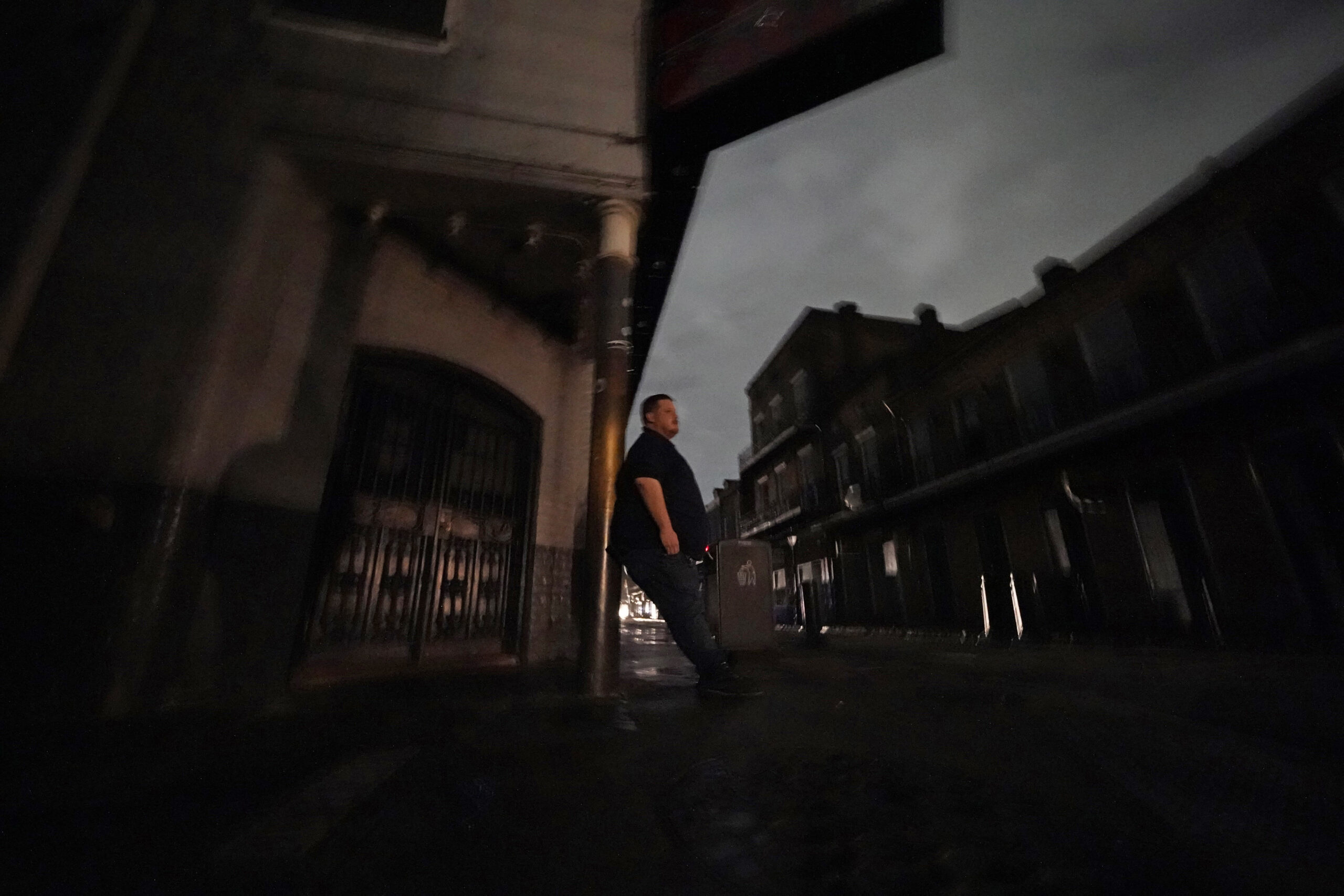 Greg Nazarko, manager of the Bourbon Bandstand bar on Bourbon Street, leans against a pole outside the club where he rode out Hurricane Ida that knocked out power in New Orleans, Monday, Aug. 30, 2021. (AP Photo/Gerald Herbert)