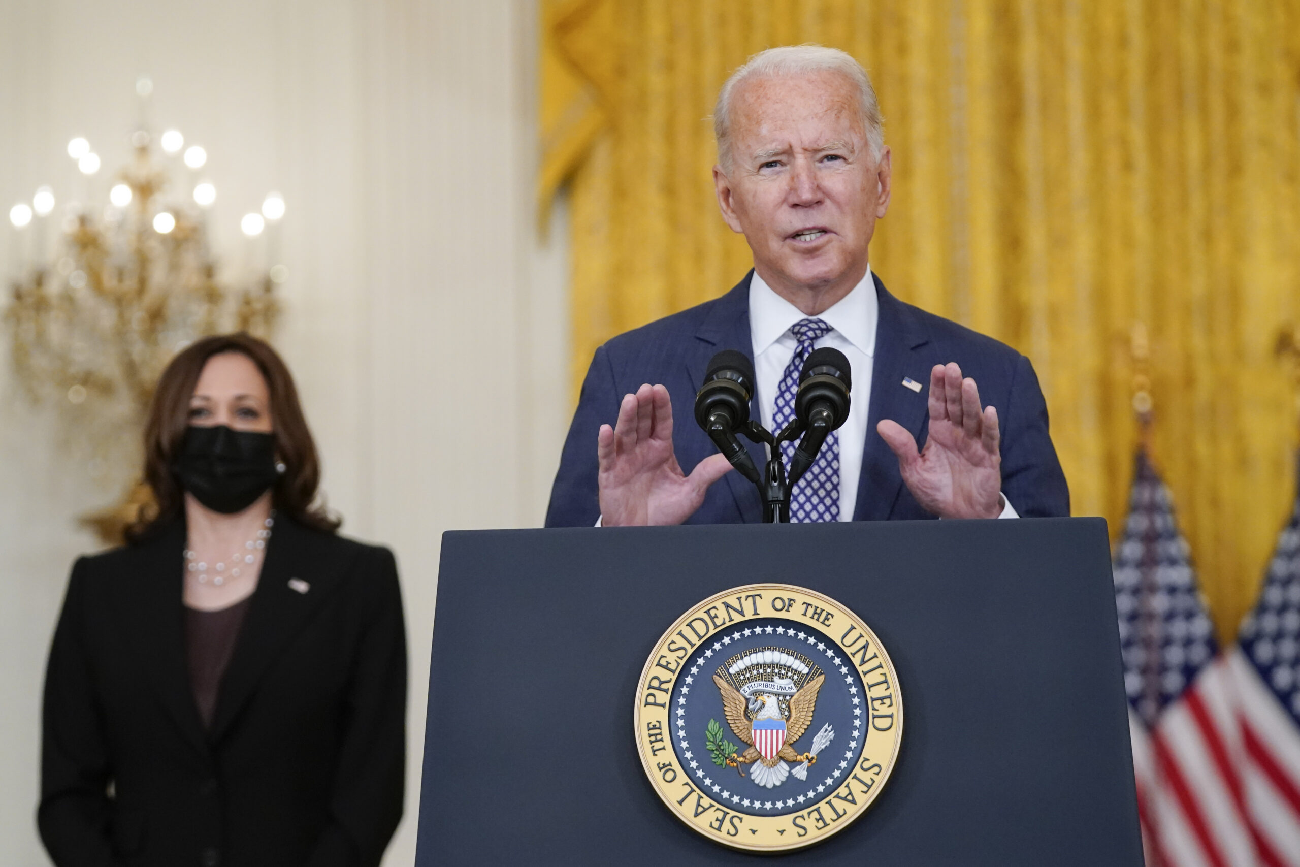 President Joe Biden speaks about the evacuation of American citizens, their families, SIV applicants and vulnerable Afghans in the East Room of the White House, Friday, Aug. 20, 2021, in Washington. Vice President Kamala Harris listens at left. (AP Photo/Manuel Balce Ceneta)