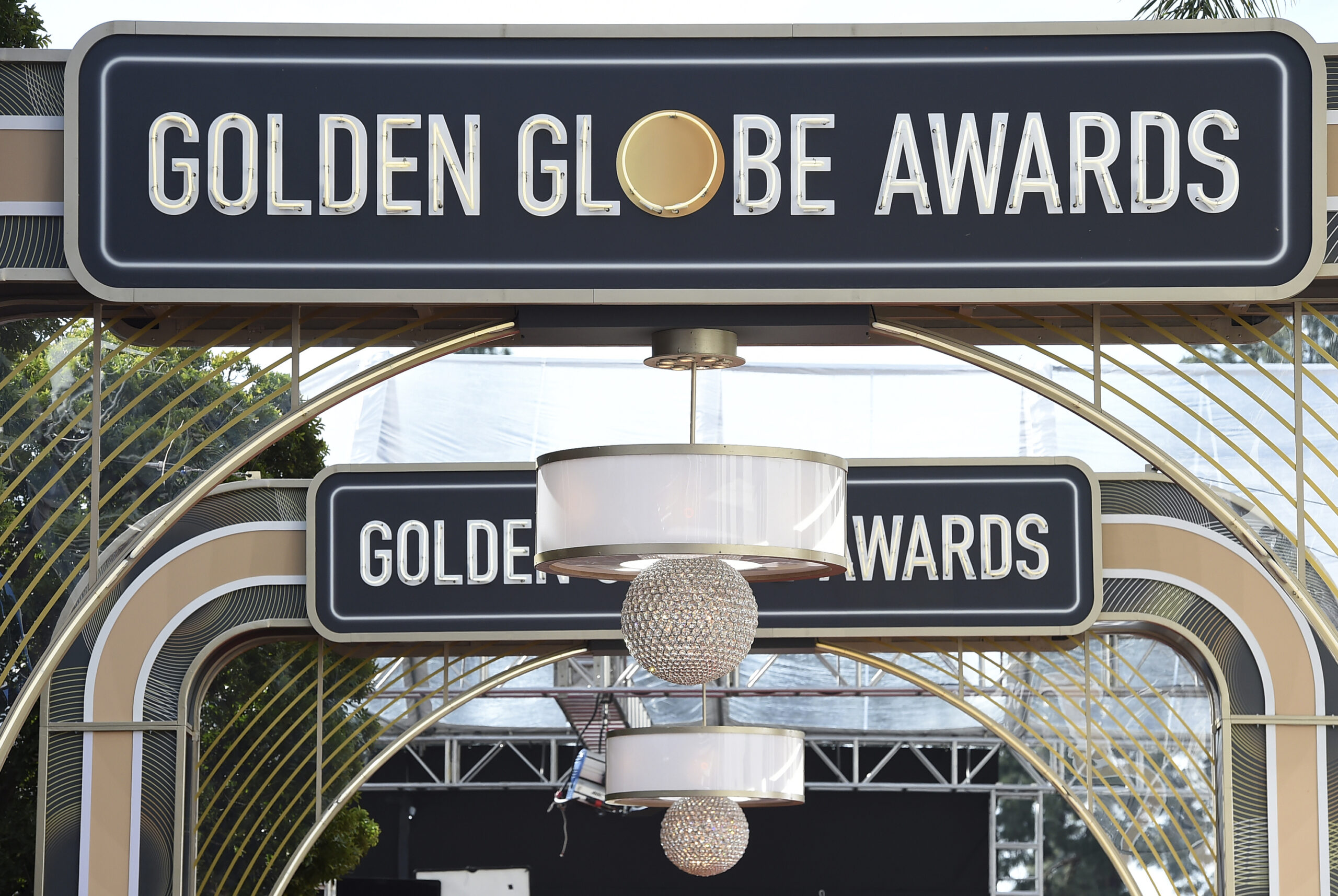 FILE - Event signage appears above the red carpet at the 77th annual Golden Globe Awards, on Jan. 5, 2020, in Beverly Hills, Calif. The Hollywood Foreign Press Association on Thursday announced reforms to its bylaws and an overhaul of its membership process in a bid to diversify its ranks and potentially restore the heavily criticized Golden Globes. (Photo by Jordan Strauss/Invision/AP, File)