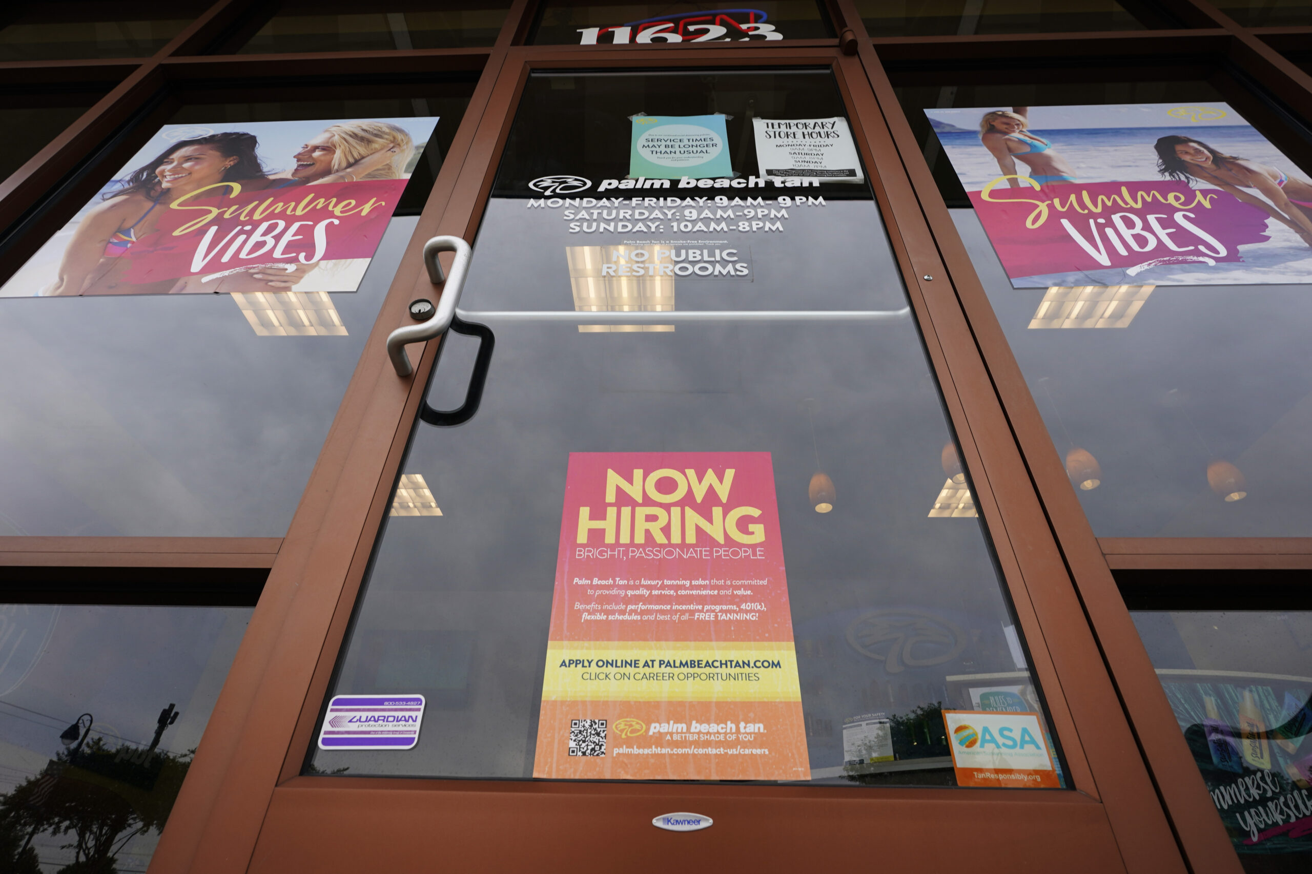 FILE - A Now Hiring sign at a business in Richmond, Va., Wednesday, June 2, 2021. U.S. employers posted a record 10.1 million job openings in June, another sign that the job market and economy are bouncing back briskly from last year’s coronavirus shutdowns. The Labor Department reported Monday, Aug. 9, 2021 that job openings rose from 9.5 million in May. (AP Photo/Steve Helber)