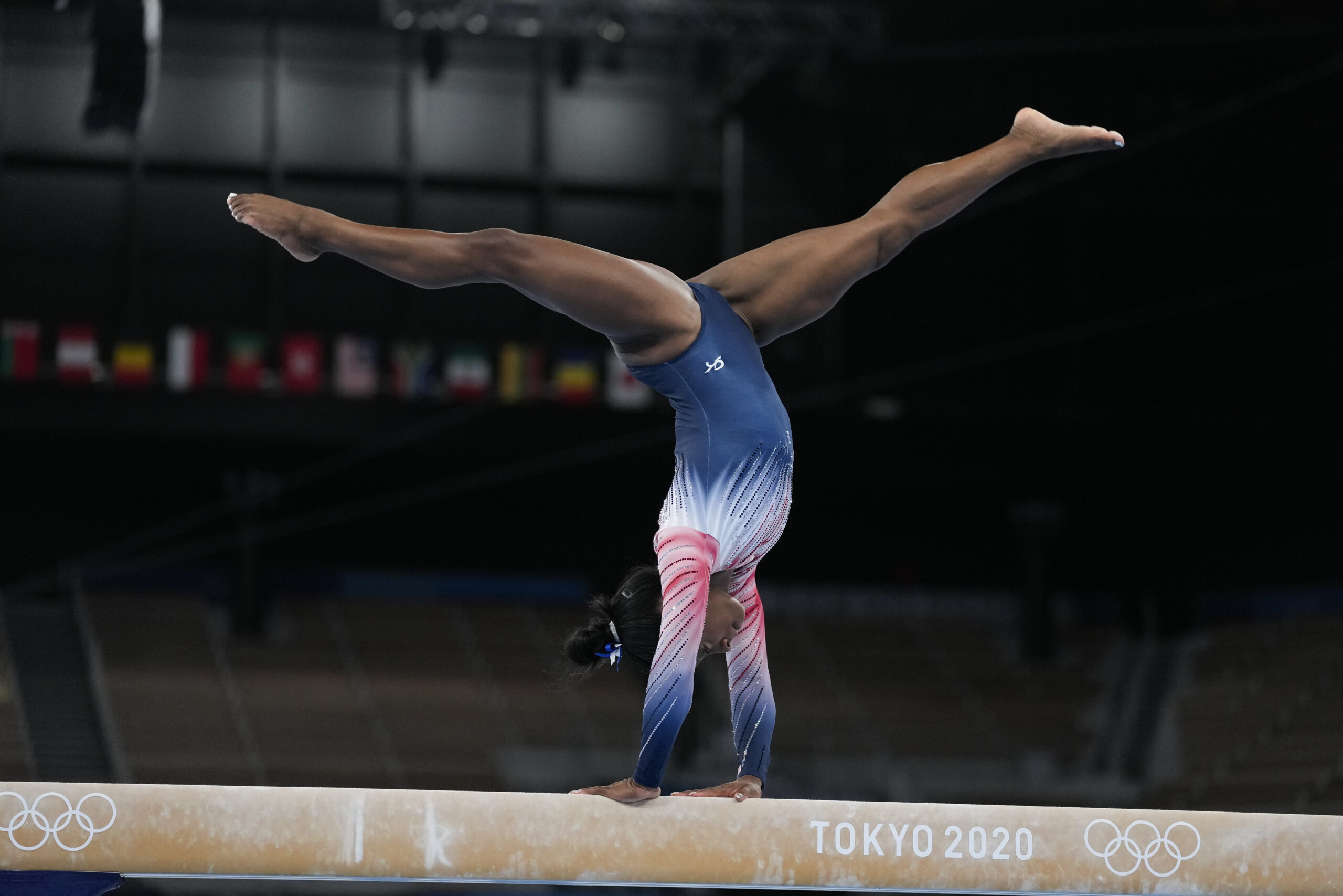 Simone Biles, of the United States, warms up prior to the artistic gymnastics balance beam final at the 2020 Summer Olympics, Tuesday, Aug. 3, 2021, in Tokyo, Japan. (AP Photo/Ashley Landis)