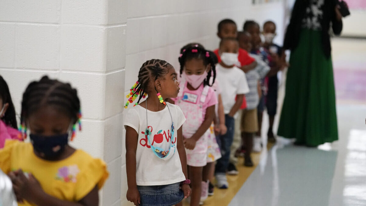 Students walk down the hallway at Tussahaw Elementary school on Wednesday, Aug. 4, 2021, in McDonough, Ga. Schools have begun reopening in the U.S. with most states leaving it up to local schools to decide whether to require masks. (AP Photo/Brynn Anderson)