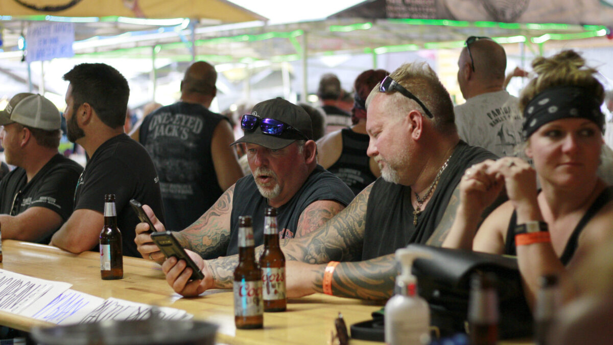 FILE - In this Aug. 7, 2020, file photo, people congregate at One-Eyed Jack's Saloon during the 80th annual Sturgis Motorcycle Rally in Sturgis, S.D. The annual Sturgis Motorcycle Rally refused to take 2020 off despite the threat of the coronavirus pandemic, a decision blamed for leading to a late-summer spike in cases across the Midwest. And it's about to roar right back this year, kicking off Friday, Aug. 6, 2021 with crowds expecting to be significantly larger even as the delta variant is rising. (AP Photo/Stephen Groves, File)