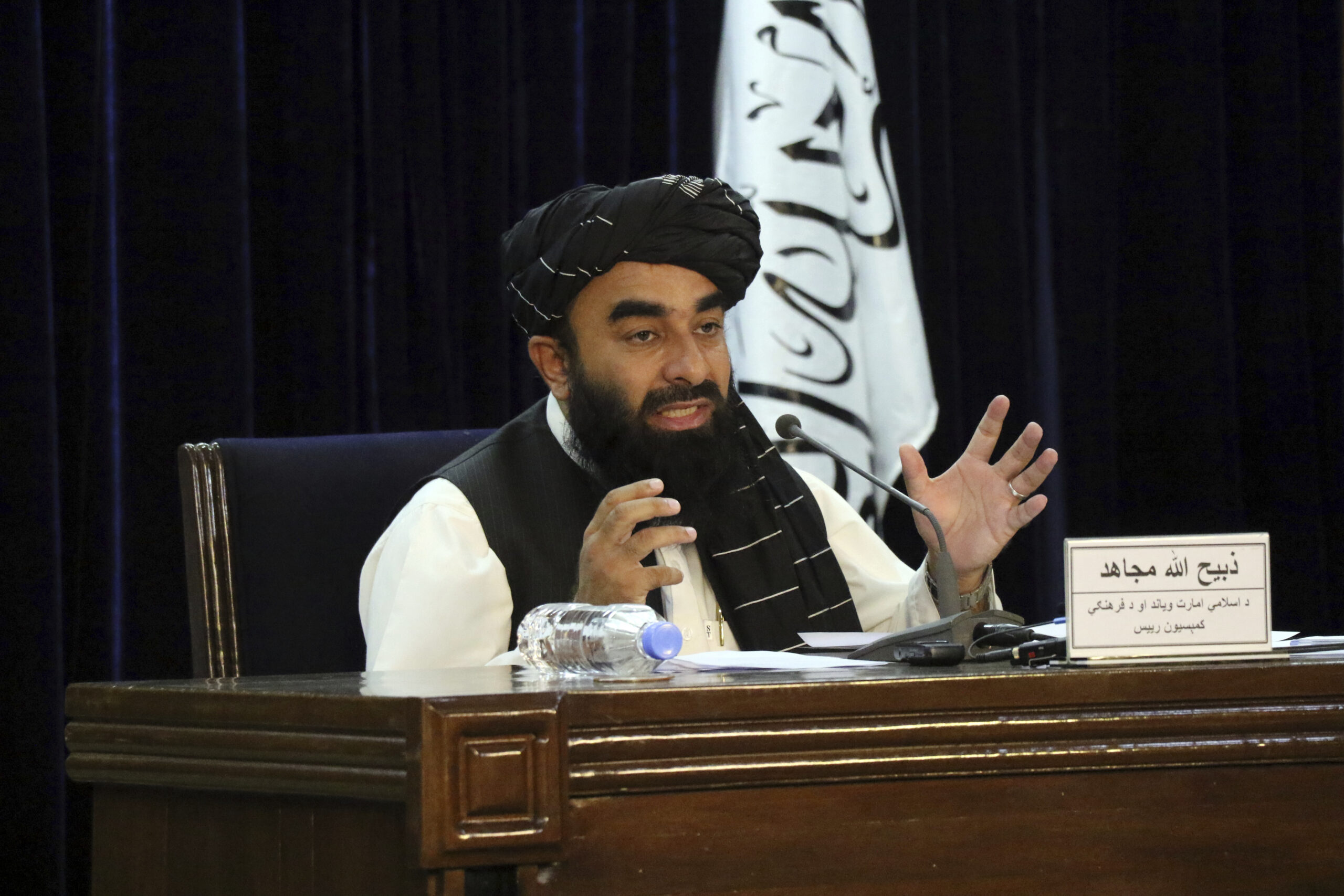 Taliban spokesman Zabihullah Mujahid speaks during a press conference in Kabul, Afghanistan Tuesday, Sept. 7, 2021. The Taliban on Tuesday announced a caretaker Cabinet stacked with veterans of their harsh rule in the late 1990s and subsequent 20-year battle against the U.S.-led coalition and its Afghan government allies. The line-up announced at the press conference is not likely to win the international support the Taliban so desperately need to avoid an economic meltdown. (AP Photo/Muhammad Farooq)