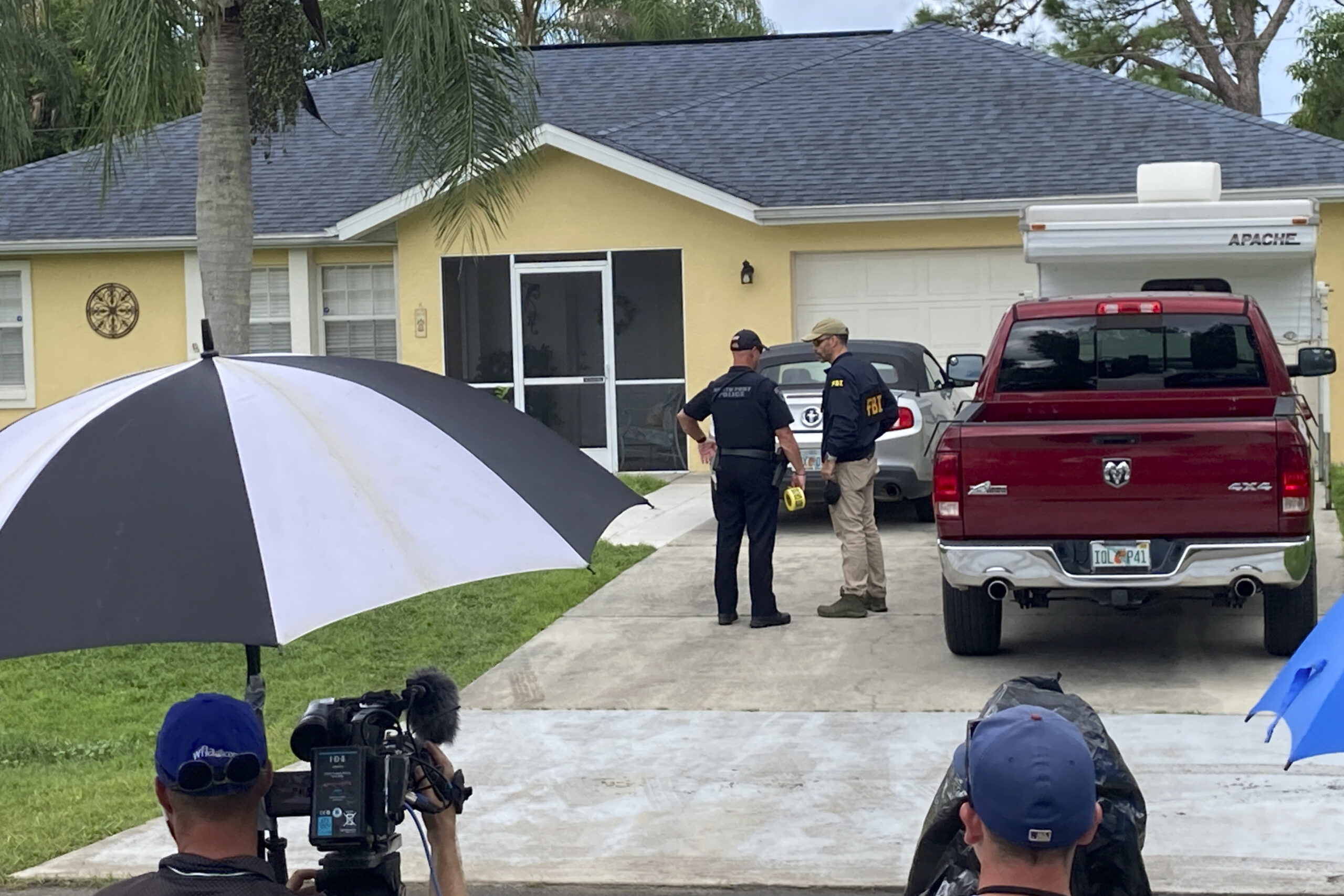 Law enforcement officials investigate home of a young man wanted for questioning in the disappearance of his girlfriend, Gabby Petito, on Monday, Sept. 20, 2021 in North Port, Fla. The officers served a search warrant at the home of the parents of her 23-year-old boyfriend Brian Laundrie, who is wanted for questioning. (AP Photo/Curt Anderson)