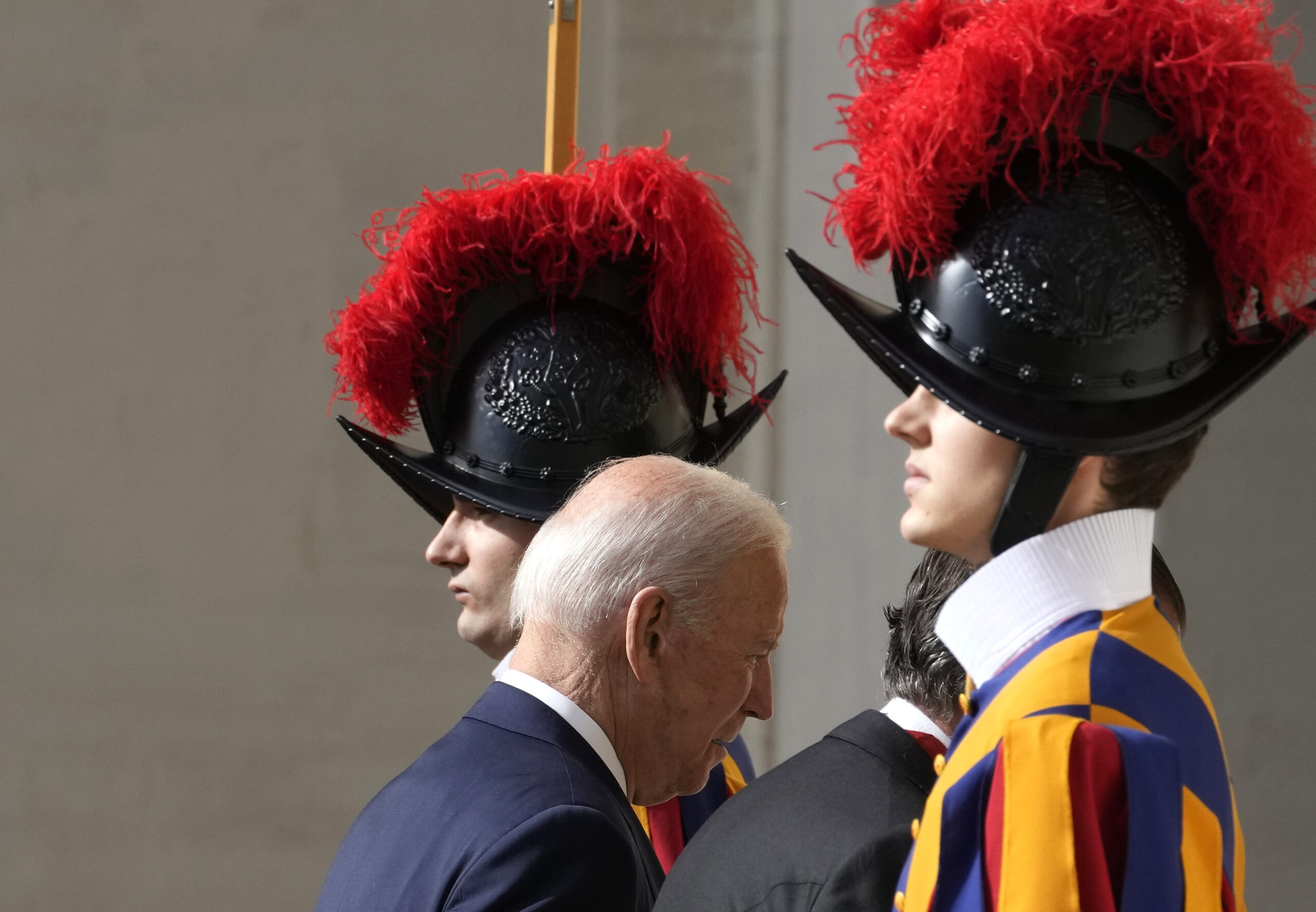 U.S. President Joe Biden walks past two Swiss Guards as he arrives for a meeting with Pope Francis at the Vatican, Friday, Oct. 29, 2021. A Group of 20 summit scheduled for this weekend in Rome is the first in-person gathering of leaders of the world's biggest economies since the COVID-19 pandemic started. (AP Photo/Andrew Medichini)