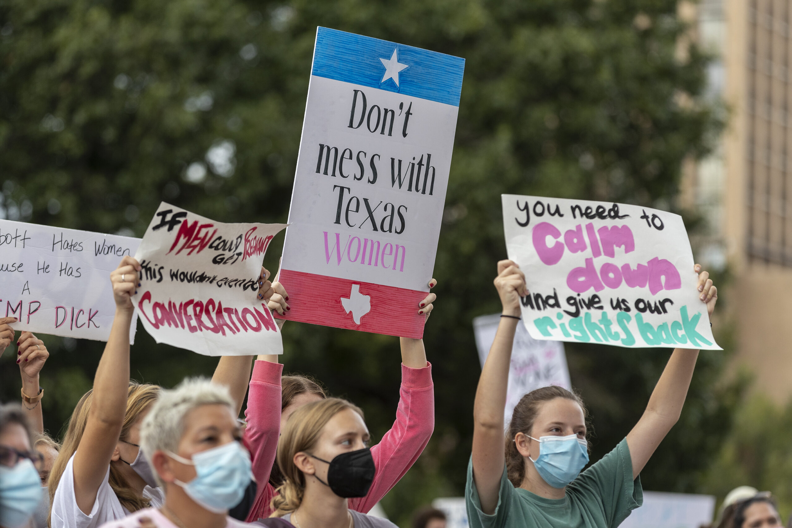 FILE - In this Oct. 2, 2021, file photo, people attend the Women's March ATX rally, at the Texas State Capitol in Austin, Texas. A federal judge has ordered Texas to suspend a new law that has banned most abortions in the state since September. The order Wednesday by U.S. District Judge Robert Pitman freezes for now the strict abortion law known as Senate Bill 8. (AP Photo/Stephen Spillman, File)