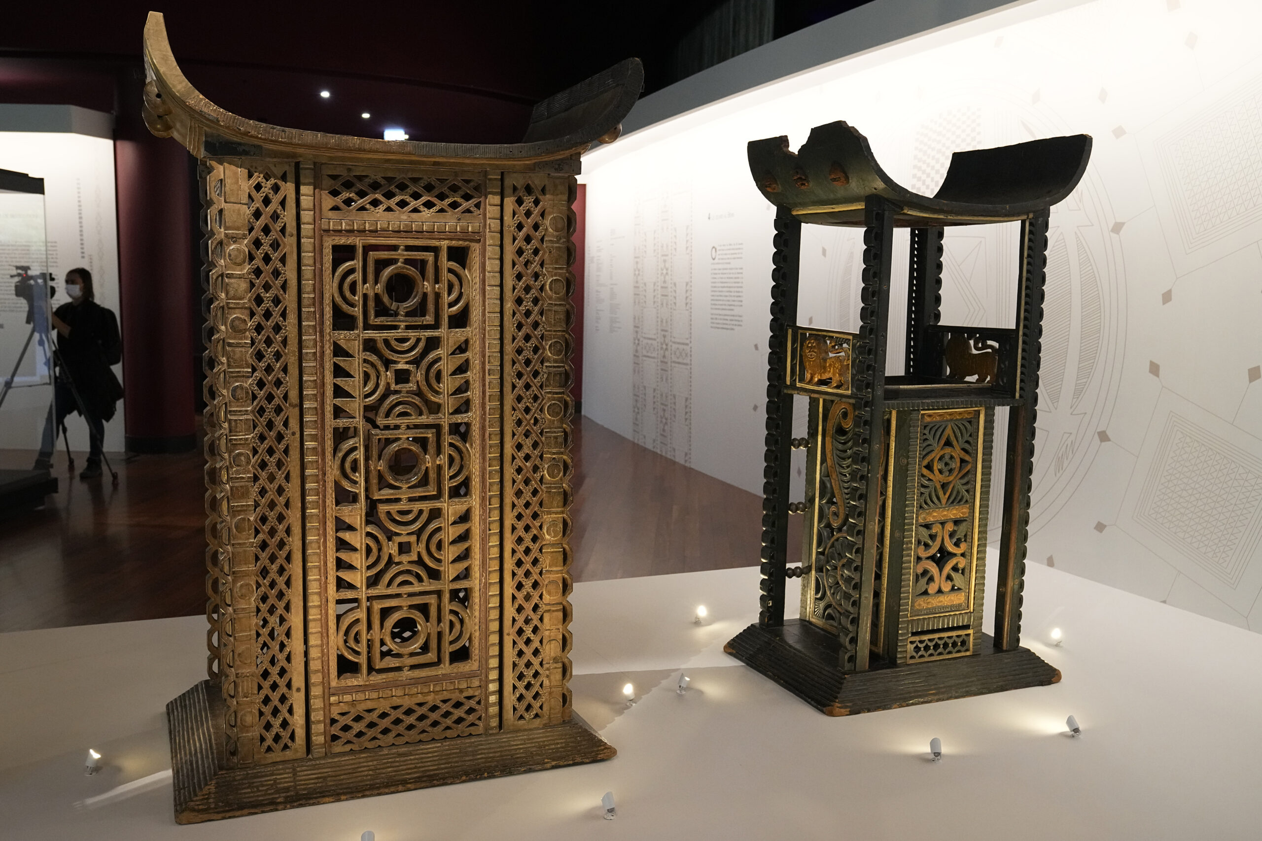 The 19th century Throne of King Ghezo, left, and Throne of King Glele, from Benin, are pictured at the Quai Branly–Jacques Chirac museum, Monday, Oct. 25, 2021 in Paris. n a decision with potential ramifications across European museums, France is displaying 26 looted colonial-era artifacts for one last time before returning them home to Benin. The wooden anthropomorphic statues, royal thrones and sacred altars were pilfered by the French army in the 19th century from Western Africa. (AP Photo/Michel Euler)