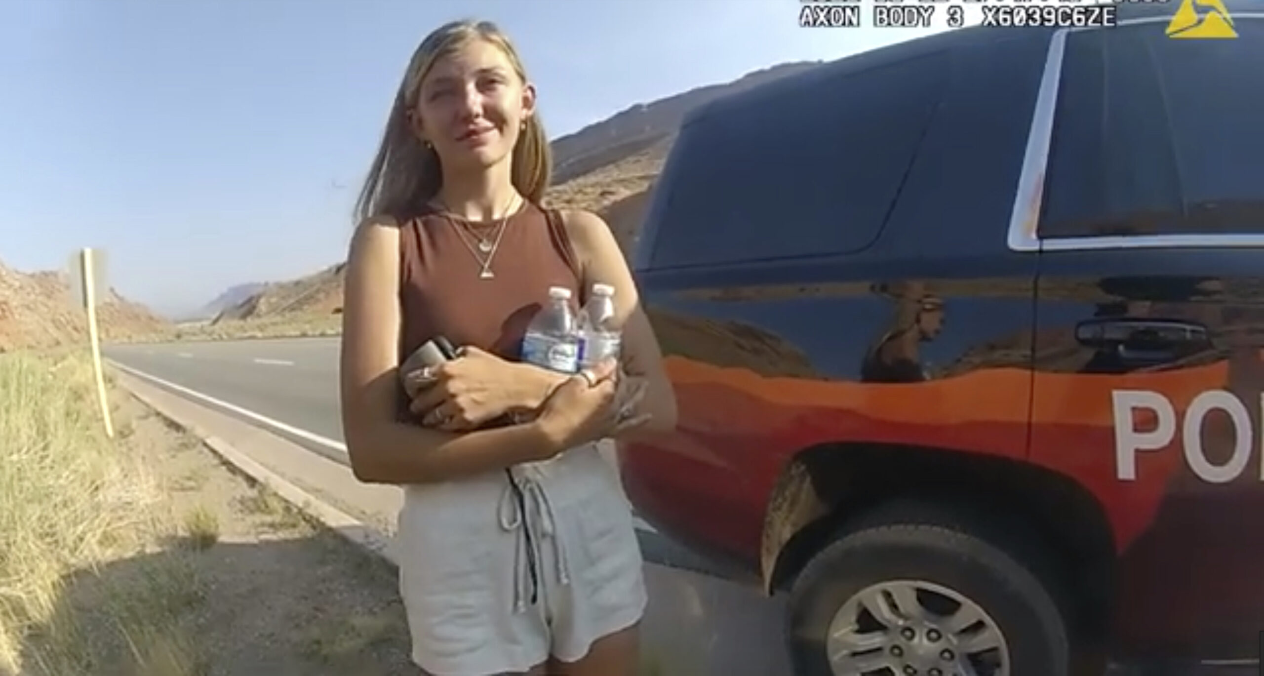 FILE - This police camera video provided by The Moab Police Department shows Gabrielle "Gabby" Petito talking to a police officer after police pulled over the van she was traveling in with her boyfriend, Brian Laundrie, near the entrance to Arches National Park on Aug. 12, 2021. Teton County Coroner Brent Blue is scheduled to announce the findings of Petito's autopsy at a news conference early Tuesday, Oct. 12. (The Moab Police Department via AP)