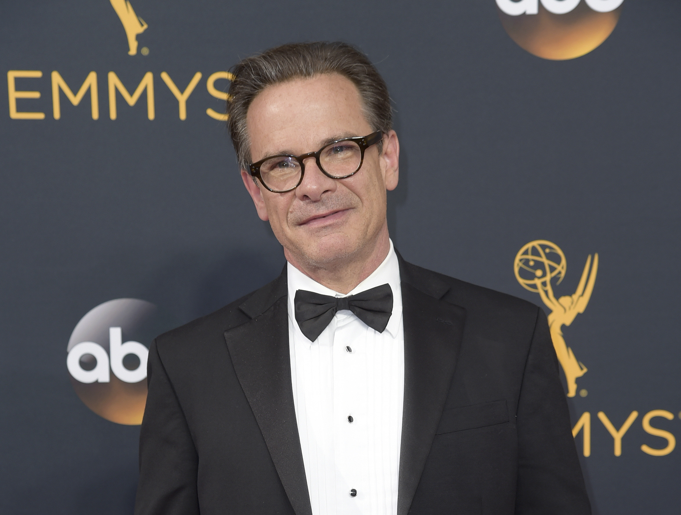 FILE - Peter Scolari arrives at the 68th Primetime Emmy Awards in Los Angeles on Sept. 18, 2016. Scolari, a versatile character actor whose television roles included a yuppie producer on “Newhart” and a closeted dad on “Girls” and who was on Broadway in “Hairspray” and “Wicked,” died Friday morning in New York after fighting cancer for two years, according to Ellen Lubin Sanitsky, his longtime manager. He was 66. (Photo by Richard Shotwell/Invision/AP, File)