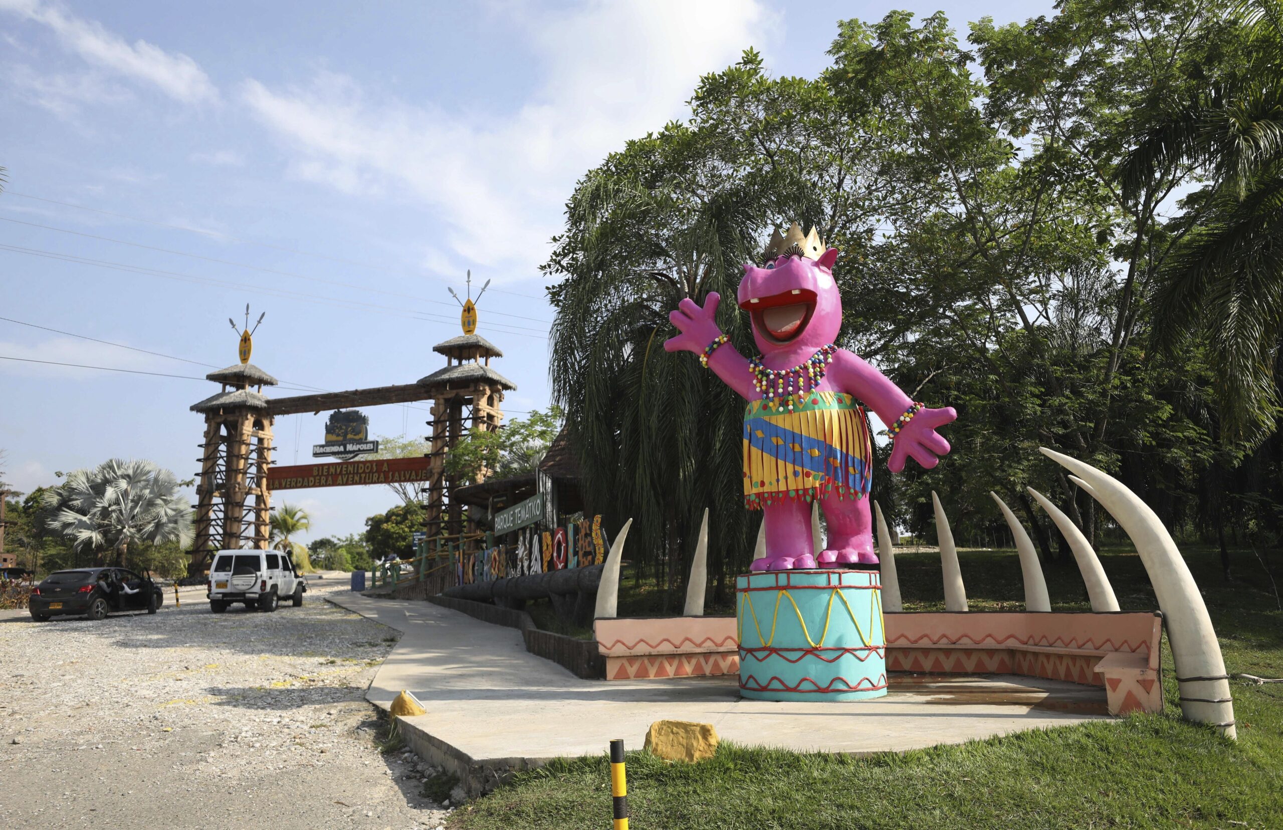 FILE—In this file photo from Feb. 4, 2021, a pink statue of a hippo greets tourists at Hacienda Napoles Park in Puerto Triunfo, Colombia. Hacienda Napoles was once a private zoo with illegally imported animals that belonged to drug trafficker Pablo Escobar. A U.S. court order says the offspring of hippos once owned by Escobar can be recognized as people with legal rights in the U.S. The case involves a lawsuit against the Colombian government over whether to kill or sterilize the hippos whose numbers are growing at a fast pace. (AP Photo/Fernando Vergara, File)
