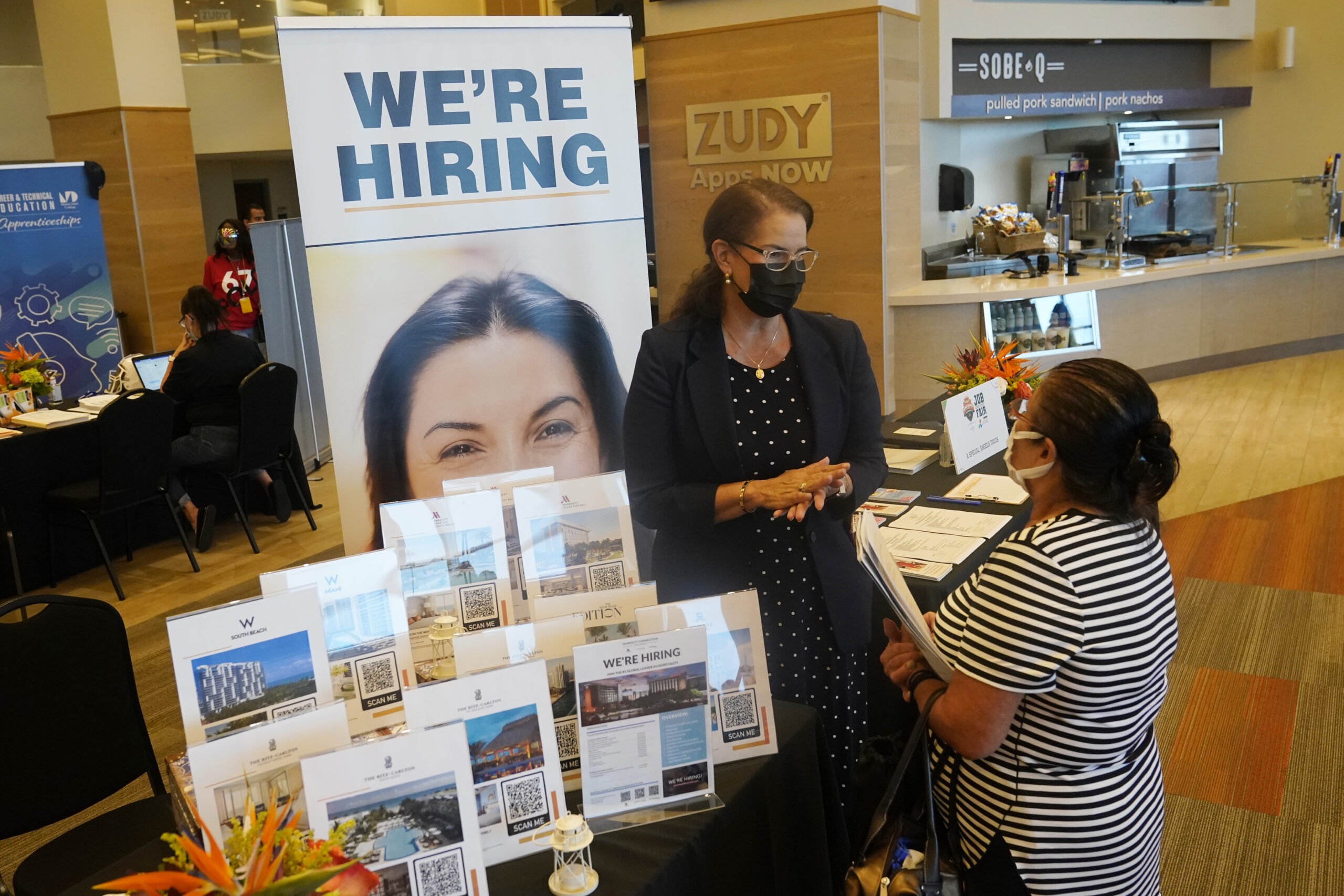 Marriott human resources recruiter Mariela Cuevas, left, talks to Lisbet Oliveros, during a job fair at Hard Rock Stadium, Friday, Sept. 3, 2021, in Miami Gardens, Fla. The number of Americans seeking unemployment benefits moved up last week to 332,000 from a pandemic low, a sign that worsening COVID-19 infections may have slightly increased layoffs. Applications for jobless aid rose from 312,000 the week before, the Labor Department said Thursday, Sept. 16. (AP Photo/Marta Lavandier)