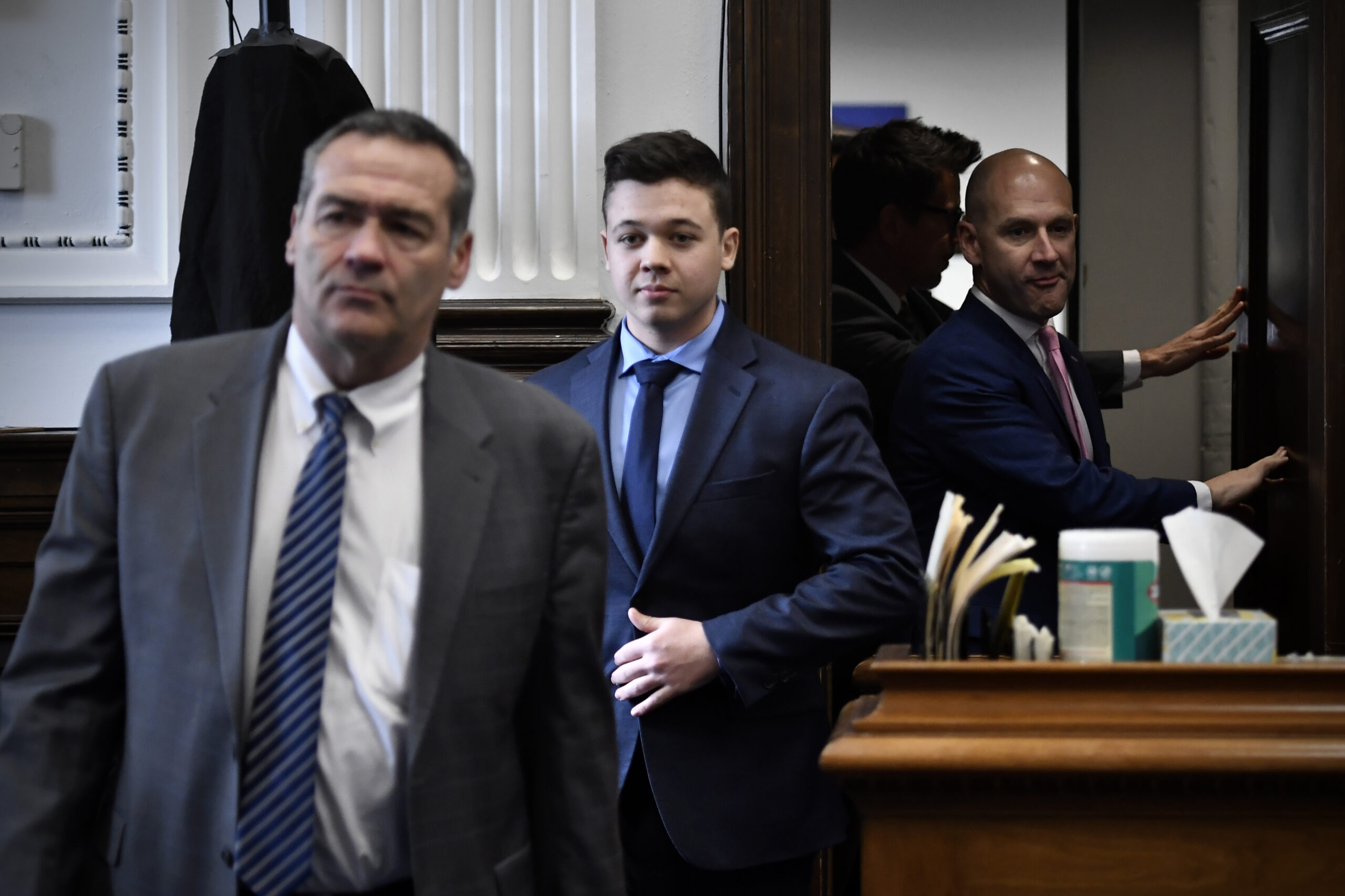 Kyle Rittenhouse, center, enters the courtroom with his attorneys Mark Richards, left, and Corey Chirafisi for a meeting called by Judge Bruce Schroeder at the Kenosha County Courthouse in Kenosha, Wis., on Thursday, Nov. 18, 2021. (Sean Krajacic/The Kenosha News via AP, Pool)