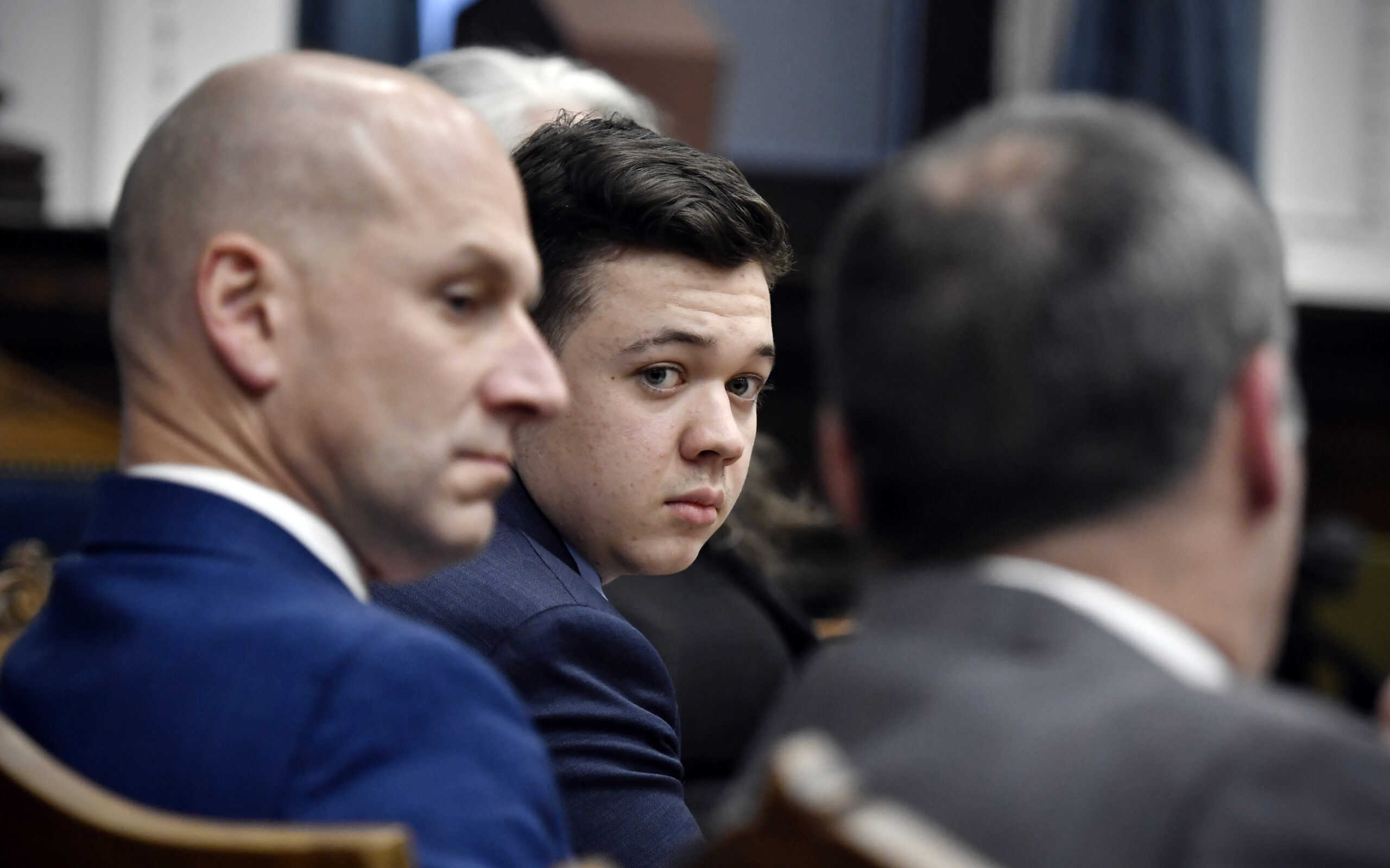 Kyle Rittenhouse, center, looks over to his attorneys as the jury is dismissed for the day during his trial at the Kenosha County Courthouse in Kenosha, Wis., on Thursday, Nov. 18, 2021. (Sean Krajacic/The Kenosha News via AP, Pool)
