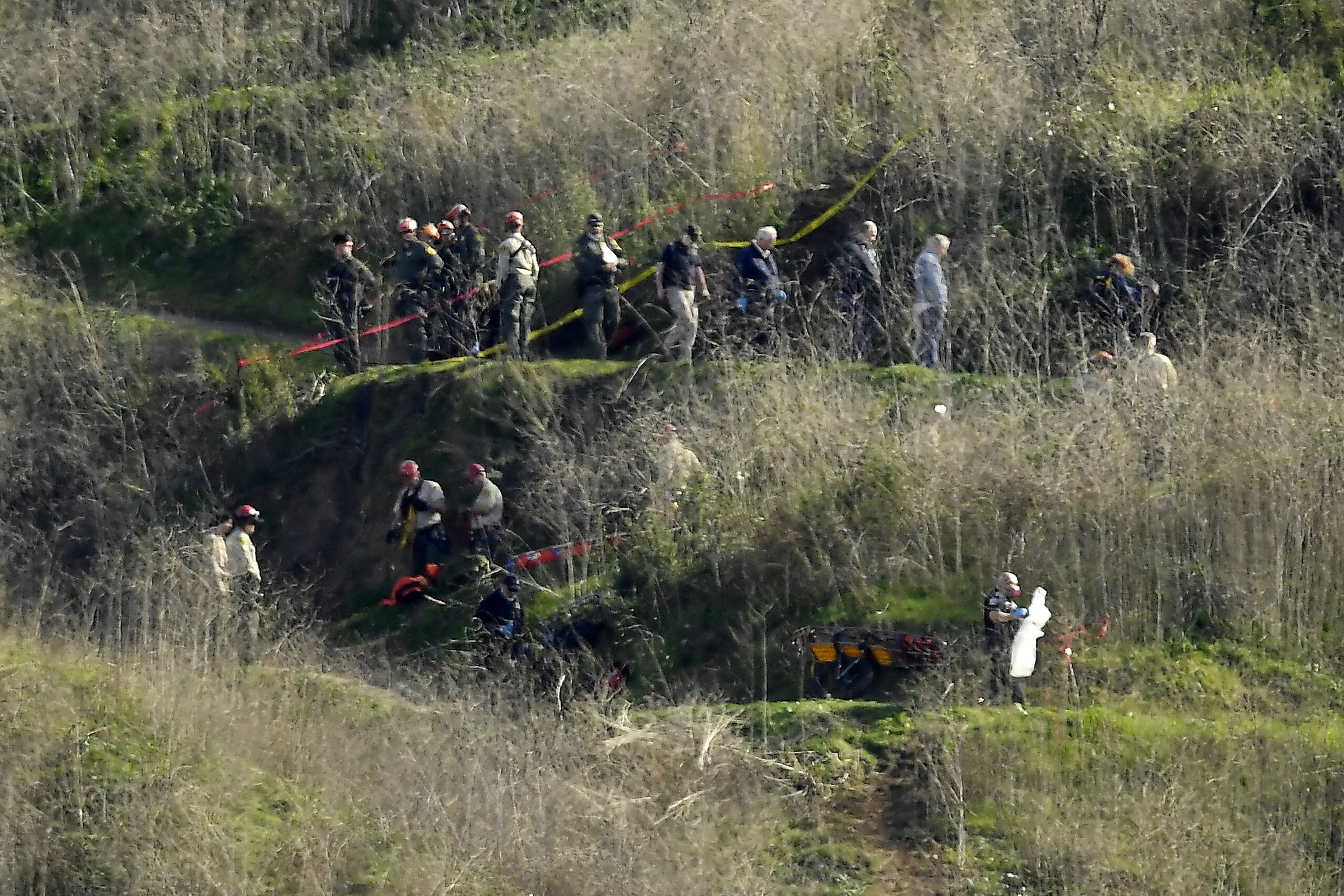 FILE - Investigators work the scene of a helicopter crash that killed former NBA basketball player Kobe Bryant and his teenage daughter, in Calabasas, Calif., on Jan. 27, 2020. A federal judge ruled Monday, Nov. 1, 2021, that Bryant’s widow won't have to undergo psychiatric testing for her lawsuit over graphic photos of the 2020 helicopter crash that killed the basketball star, her 13-year-old daughter and others. (AP Photo/Mark J. Terrill, File)