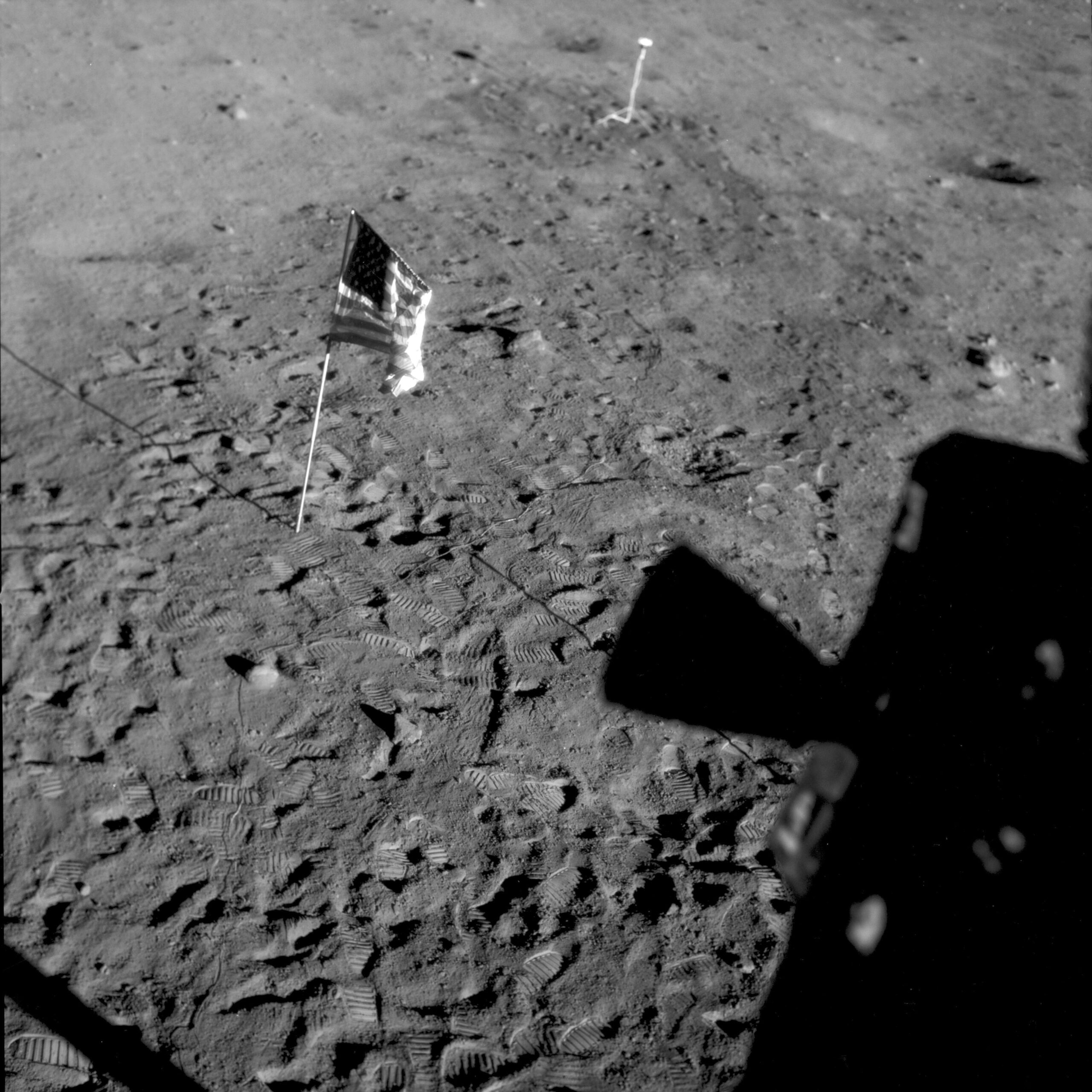 FILE - This July 21, 1969 photo made available by NASA shows a U.S. flag planted at Tranquility Base on the surface of the moon, and a silhouette of a thruster at right, seen from a window in the Lunar Module. On Tuesday, Nov. 9, 2021, NASA announced it is delaying putting astronauts back on the moon until 2025 at the earliest. (NASA via AP, File)