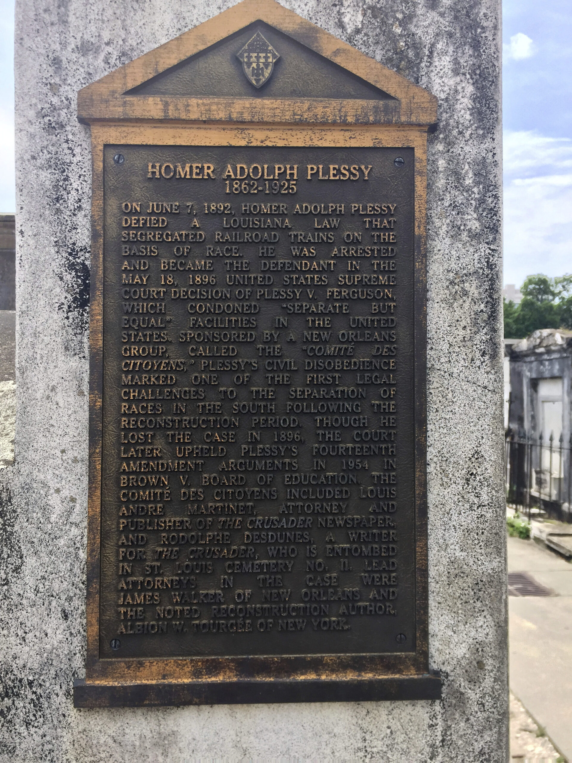 FILE - This June 3, 2018 photo shows a marker on the burial site for Homer Plessy at St. Louis No. 1 Cemetery in New Orleans. Homer Plessy, the namesake of the U.S. Supreme Court’s 1896 “separate but equal” ruling, is being considered for a posthumous pardon. The Creole man of color died with a conviction still on his record for refusing to leave a whites-only train car in New Orleans in 1892. (AP Photo/Beth J. Harpaz, File)