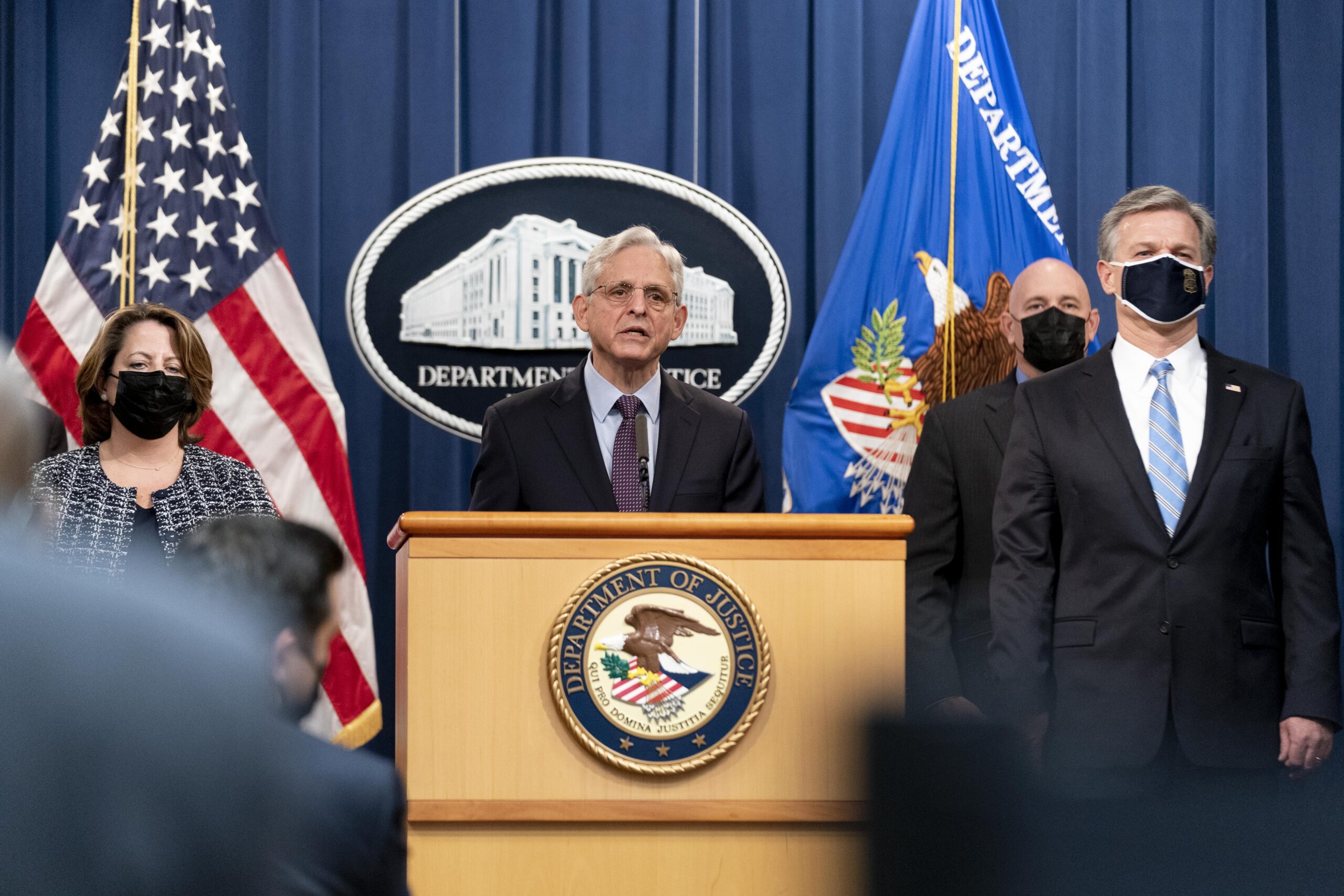 Attorney General Merrick Garland, center, accompanied by Deputy Attorney General Lisa Monaco, left, and FBI Director Christopher Wray, right, speaks at a news conference at the Justice Department in Washington, Monday, Nov. 8, 2021. (AP Photo/Andrew Harnik)