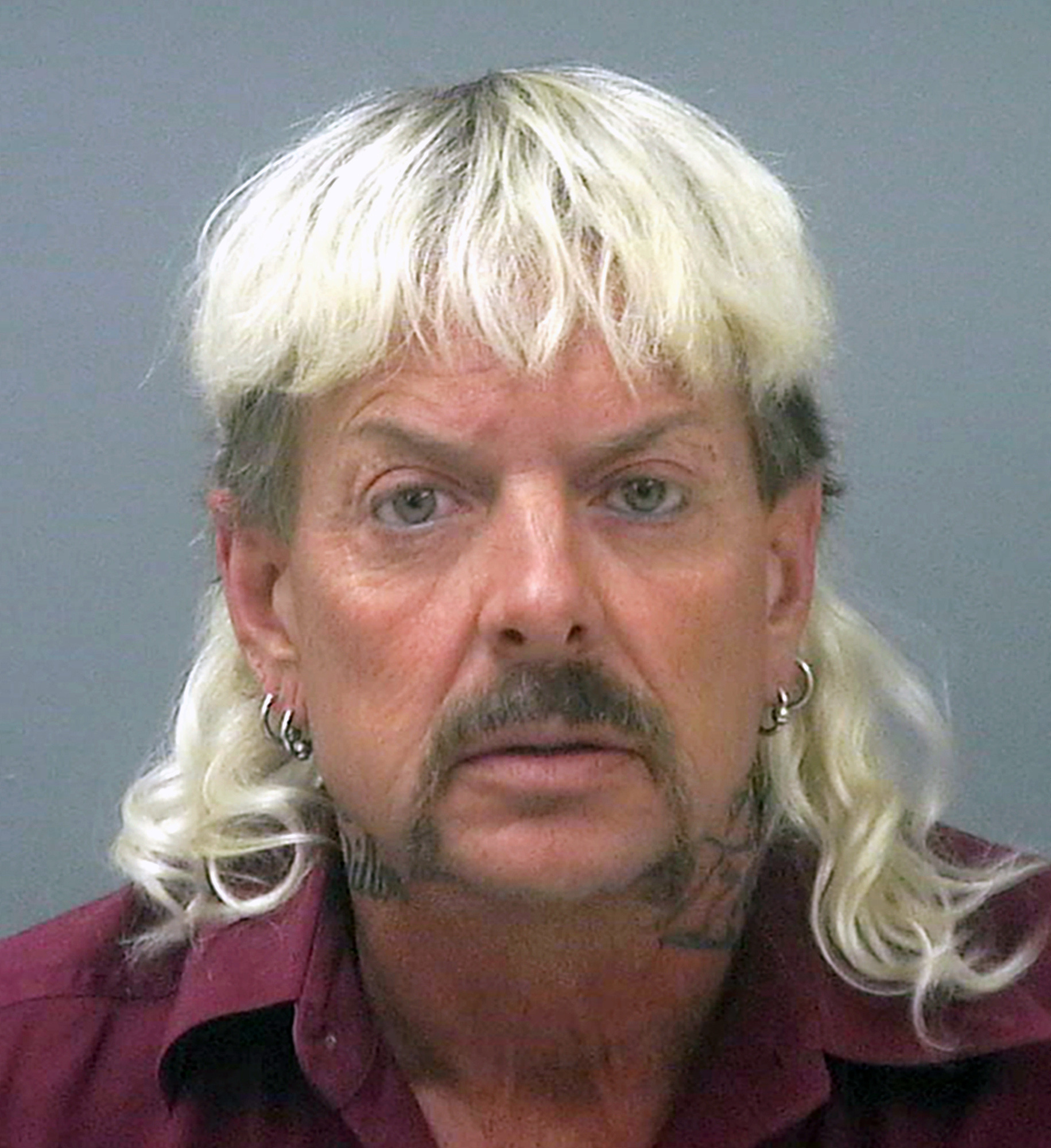 FILE - This undated file photo provided by the Santa Rose County Jail in Milton, Fla., shows Joseph Maldonado-Passage, also known as Joe Exotic. The man known as the "Tiger King" who gained fame in a Netflix documentary following his conviction for trying to hire someone to kill an animal rights activist says he has an "aggressive cancer." (Santa Rosa County Jail via AP, File)