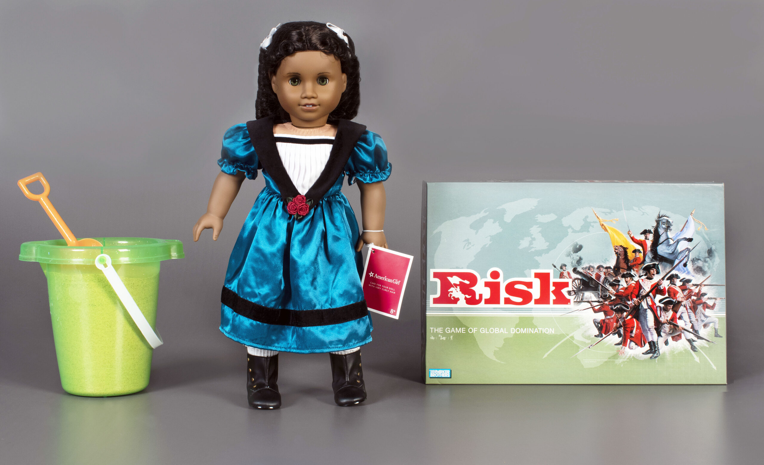 This photo, provided by The Strong National Museum of Play, shows the three toys being inducted this year into the National Toy Hall of Fame. They are, from left: sand, The American Girl Doll, and the game of Risk, that are being enshrined during a ceremony at the hall, located inside The Strong National Museum of Play, in Rochester, NY. (Strong National Museum of Play/Victoria Gray via AP)