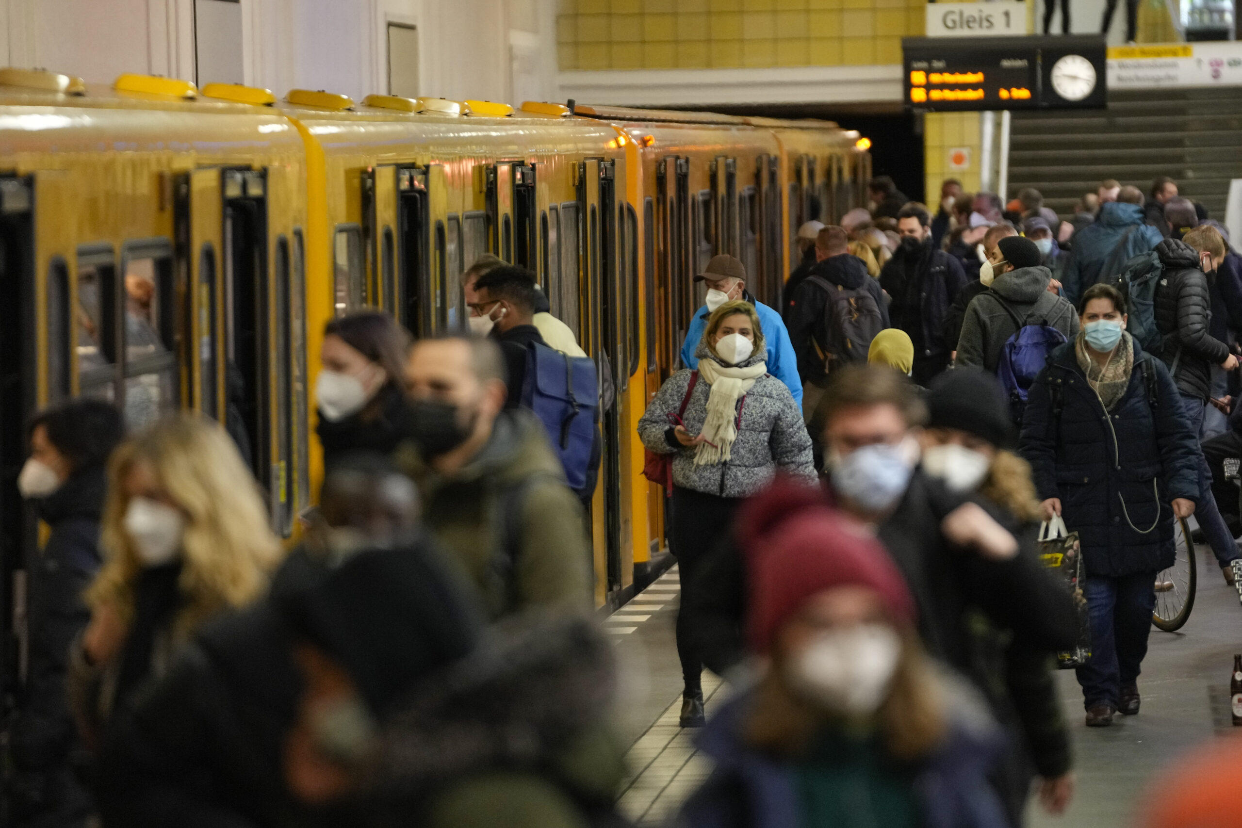 People wear face mask to protect against the coronavirus at the public transport station Friedrichstrasse in Berlin, Germany, Tuesday, Nov. 30, 2021. According to local authorities wearing face masks mandatory in public transport and passengers need to be vaccinated, recovered or tested negative of the coronavirus. (AP Photo/Markus Schreiber)