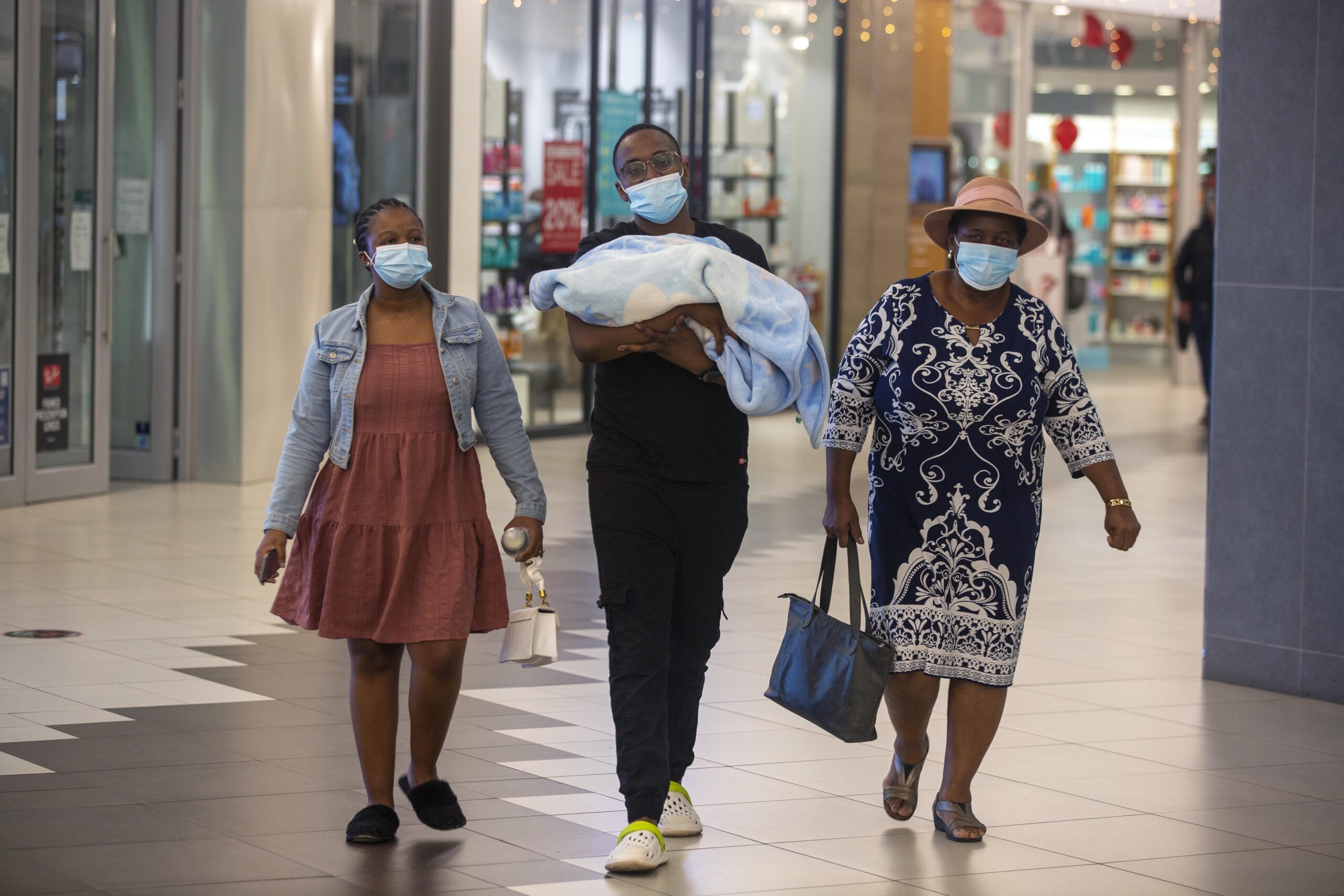 People with masks walk at a shopping mall in Johannesburg, South Africa, Friday Nov. 26, 2021. Advisers to the World Health Organization are holding a special session Friday to flesh out information about a worrying new variant of the coronavirus that has emerged in South Africa, though its impact on COVID-19 vaccines may not be known for weeks. (AP Photo/Denis Farrell)