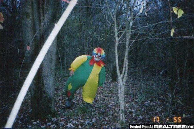A clown was caught on a trail camera photograph in the woods also known as a game camera.