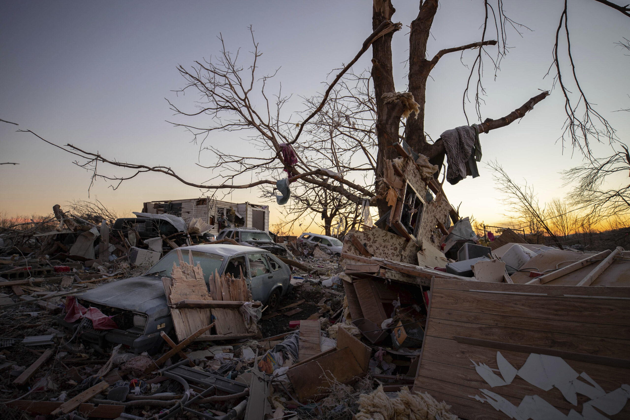 A car sits among the remains of a destroyed house after a tornado in Dawson Springs, Ky., Sunday, Dec. 12, 2021. A monstrous tornado, carving a track that could rival the longest on record, ripped across the middle of the U.S. on Friday. (AP Photo/Michael Clubb)