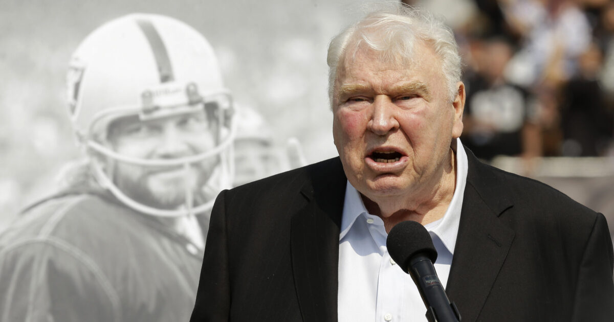 FILE - Former Oakland Raiders head coach John Madden speaks about former quarterback Ken Stabler, pictured at rear, at a ceremony honoring Stabler during halftime of an NFL football game between the Raiders and the Cincinnati Bengals in Oakland, Calif., on Sept. 13, 2015. 'All Madden' documentary a labor of love for Fox Sports. Many gamers will be receiving the latest edition of the “Madden” video game for the holidays. On Saturday, Dec. 25, 2021, some will even find out for the first time that the name behind the popular franchise was a successful coach and broadcaster. (AP Photo/Ben Margot, File)