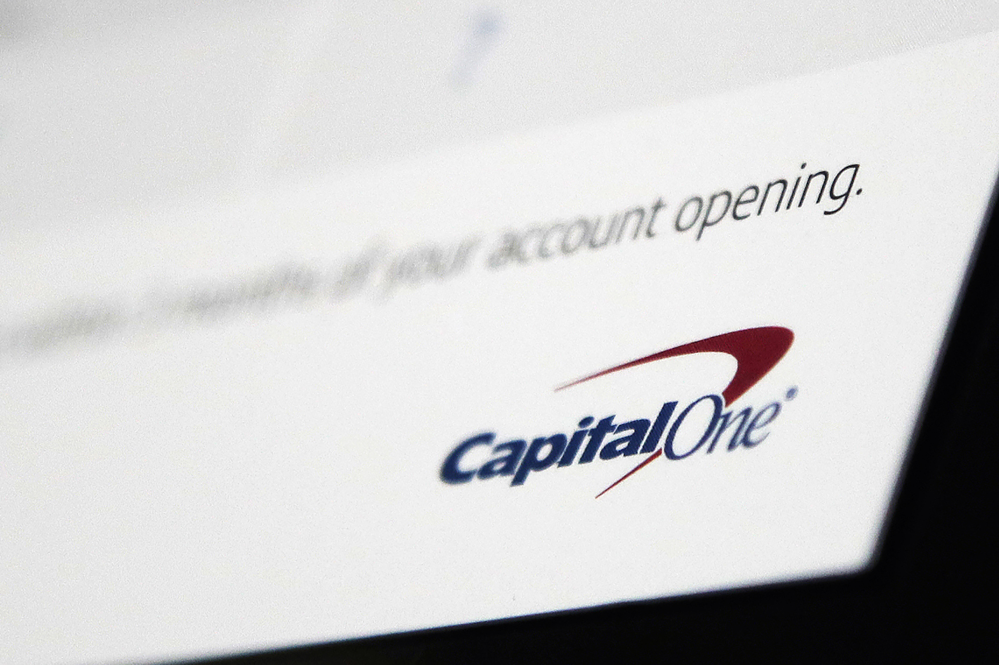 FILE - This July 22, 2019, file photo, shows a Capital One mailing in North Andover, Mass. After decades of raking in billions of dollars from mostly poor Americans short of cash in their accounts, the biggest banks, under pressure from lawmakers and regulators, are slowly decreasing their reliance on the widely unpopular practice. Capital One, the nation's sixth-largest bank, has announced that it will end all overdraft fees in 2022. Other banks have made it harder for customers to trigger an overdraft fee. (AP Photo/Elise Amendola, File)