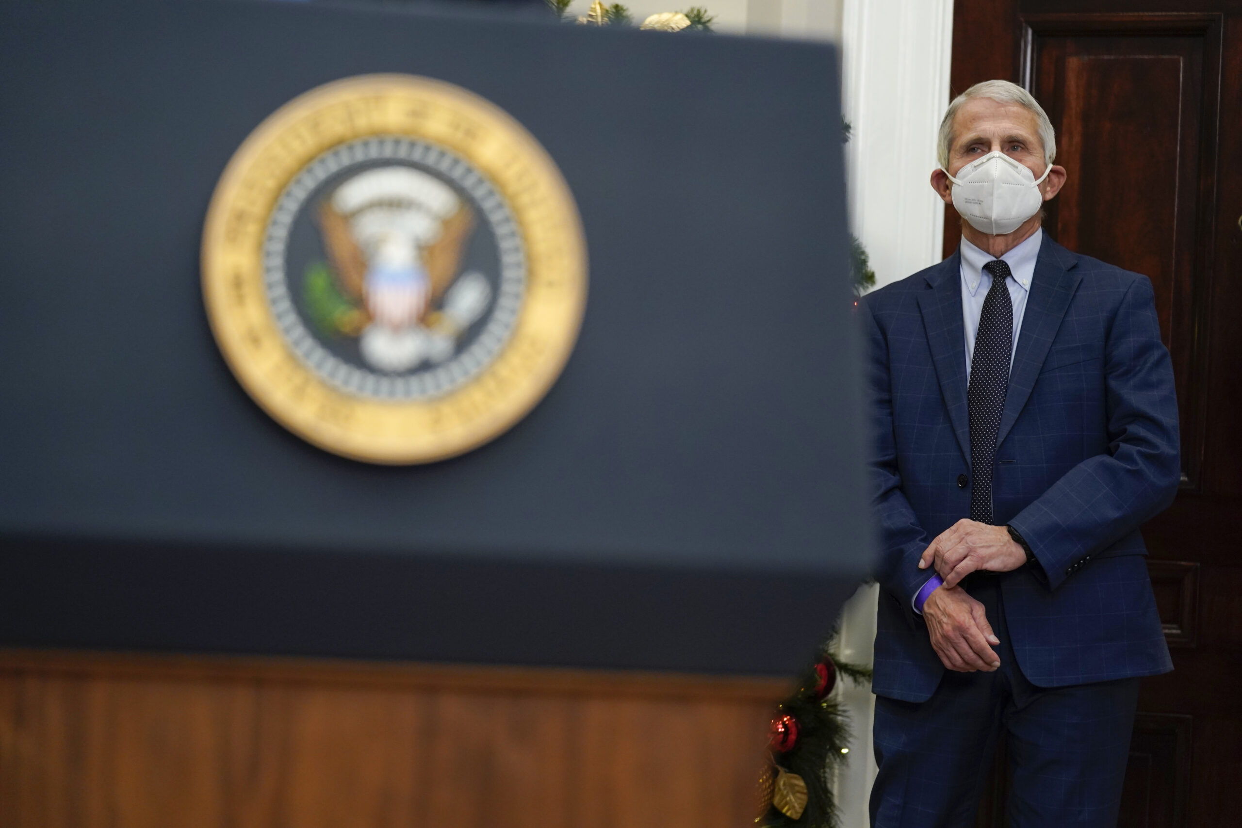 Dr. Anthony Fauci, director of the National Institute of Allergy listens as President Joe Biden speaks about the COVID-19 variant named omicron, in the Roosevelt Room of the White House, Monday, Nov. 29, 2021, in Washington. (AP Photo/Evan Vucci)