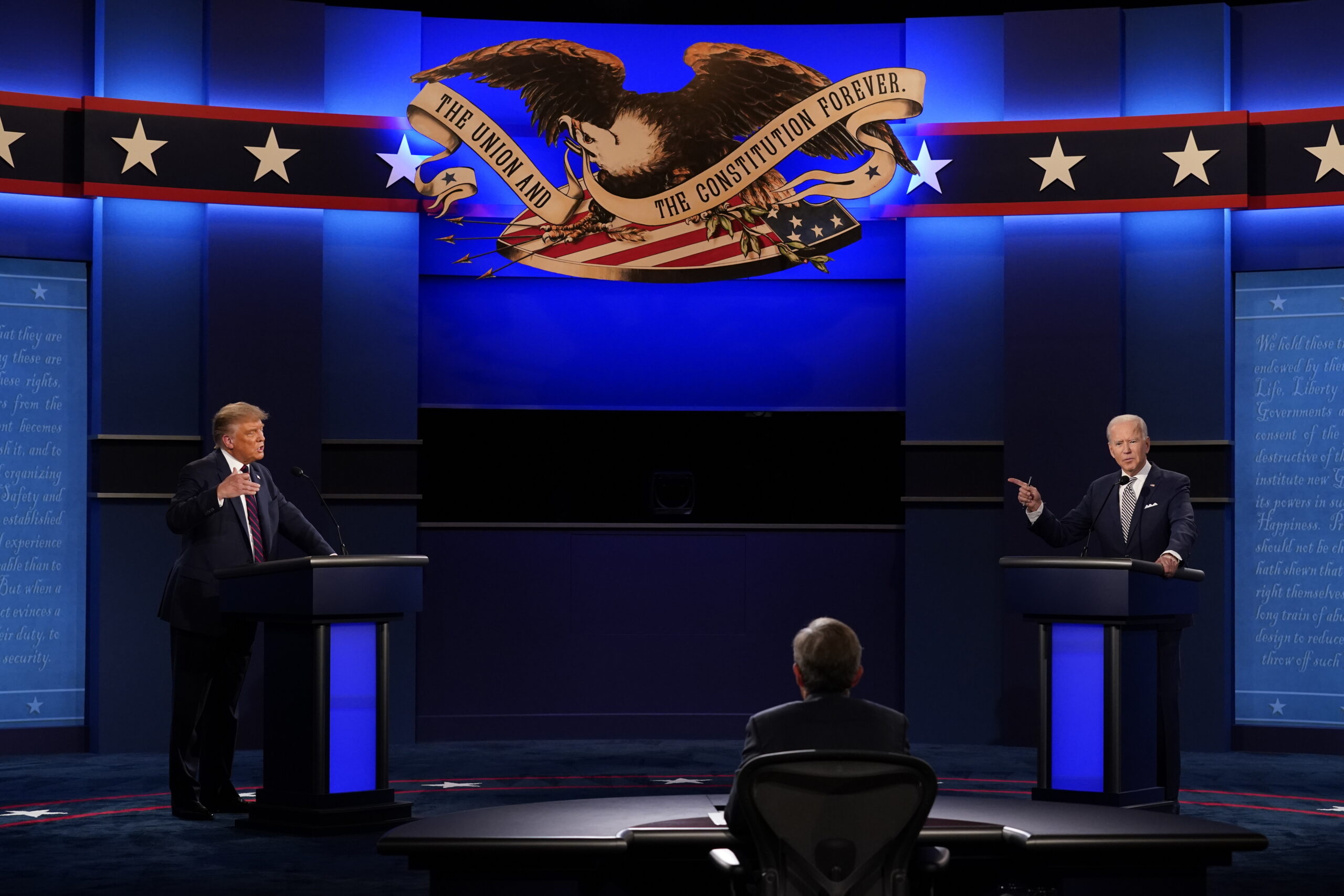 FILE - President Donald Trump, left, and Democratic presidential candidate former Vice President Joe Biden, right, with moderator Chris Wallace, center, of Fox News during the first presidential debate on Sept. 29, 2020, at Case Western University and Cleveland Clinic, in Cleveland, Ohio. (AP Photo/Patrick Semansky, File)