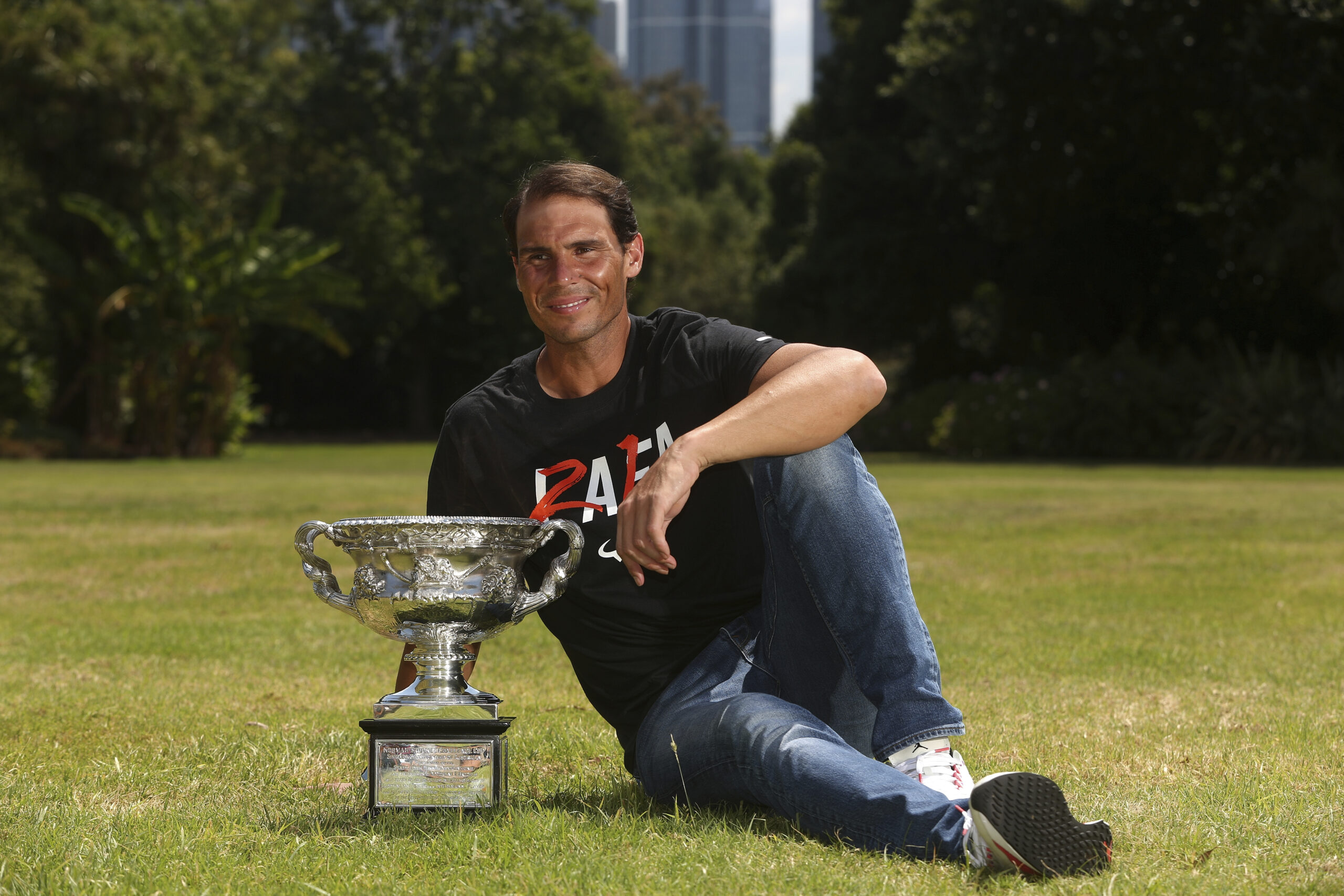 Men's singles champion Rafael Nadal of Spain poses for a photo with his trophy at Government House after the Australian Open in Melbourne, Australia, Monday, Jan. 31, 2022. (AP Photo/Hamish Blair)
