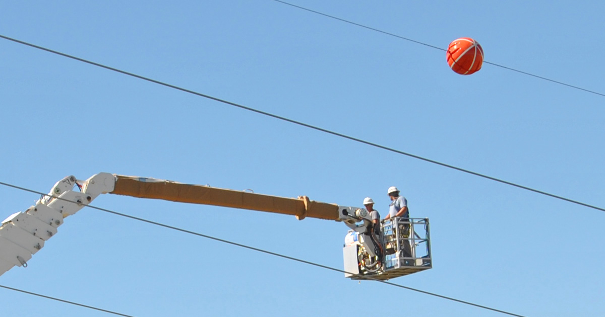 Colored balls on power lines whether red orange white or yellow are for aircraft safety and are often referred to as marker or visibility balls.