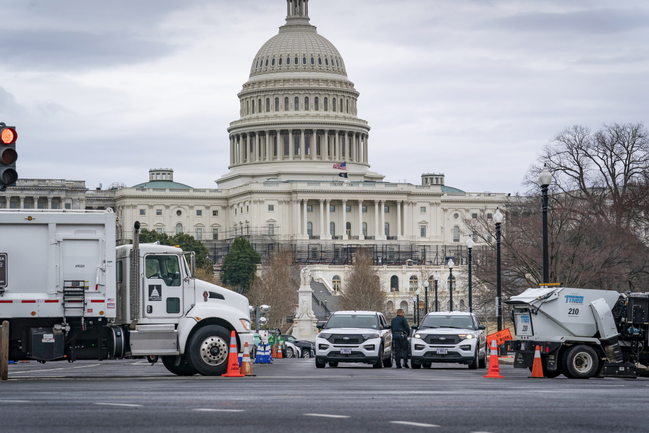 Heavy vehicles, including garbage trucks and snow plows, are set near the entrance to Capitol Hill at Pennsylvania Avenue and 3rd Street NW in Washington, Tuesday, Feb. 22, 2022, amid reports that trucker protests will arrive on March 1, the day of President Joe Biden's State of the Union address. (AP Photo/J. Scott Applewhite)