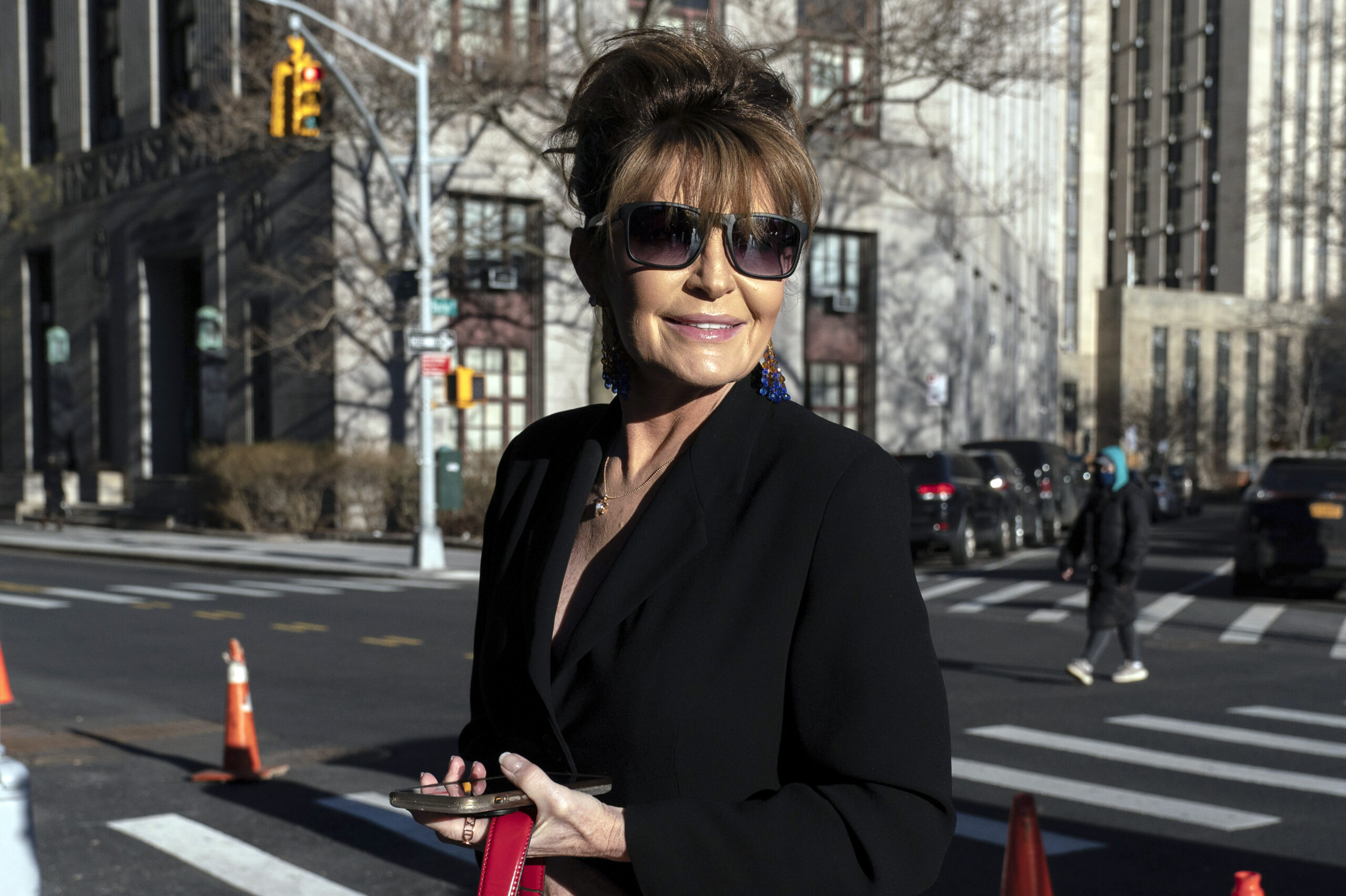 FILE - Former Alaska Gov. Sarah Palin arrives at federal court in New York, Feb. 11, 2022. A judge said Monday he’ll dismiss a libel lawsuit that Palin filed against The New York Times, saying Palin had failed to show that The Times had acted out of malice, something required in libel lawsuits involving public figures. (AP Photo/Jeenah Moon, File)