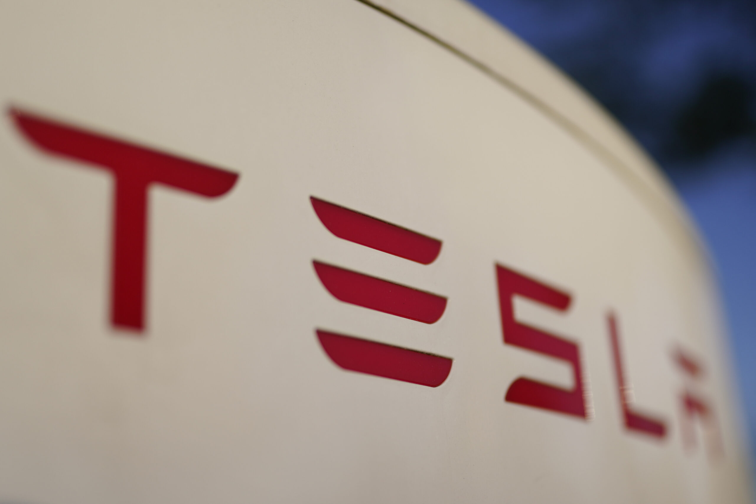 FILE - The logo for the Tesla Supercharger station is seen in Buford, Ga, April 22, 2021,. Tesla is recalling nearly 579,000 vehicles in the U.S. because sounds played over an external speaker can obscure audible warnings for pedestrians. The recall is the fourth made public in the last two weeks as U.S. safety regulators increase scrutiny of the nation’s largest electric vehicle maker. (AP Photo/Chris Carlson, File)