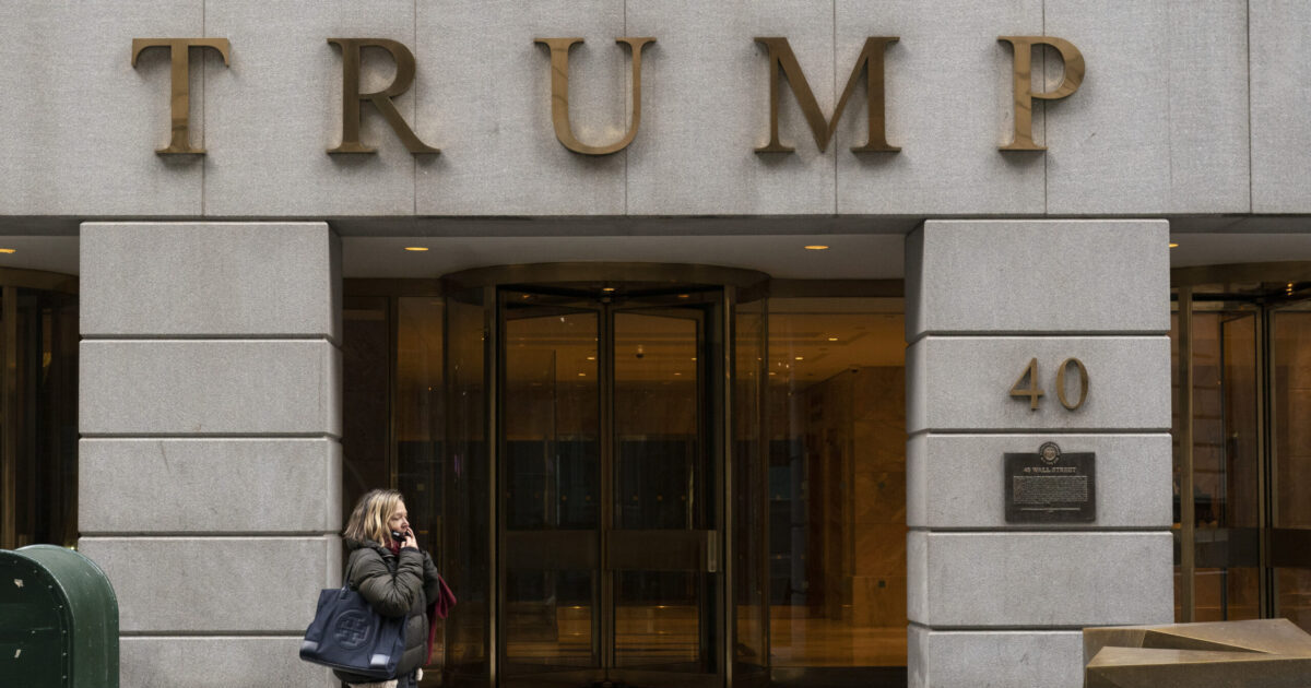 FILE - A woman walks past the Trump Building in New York's financial district, Wednesday, Jan. 13, 2021. Mazars USA LLP, the accounting firm that prepared former President Donald Trump’s annual financial statements, says the documents “should no longer be relied upon” after investigators said they found evidence he and his company regularly misstated the value of assets. (AP Photo/Mark Lennihan, File)