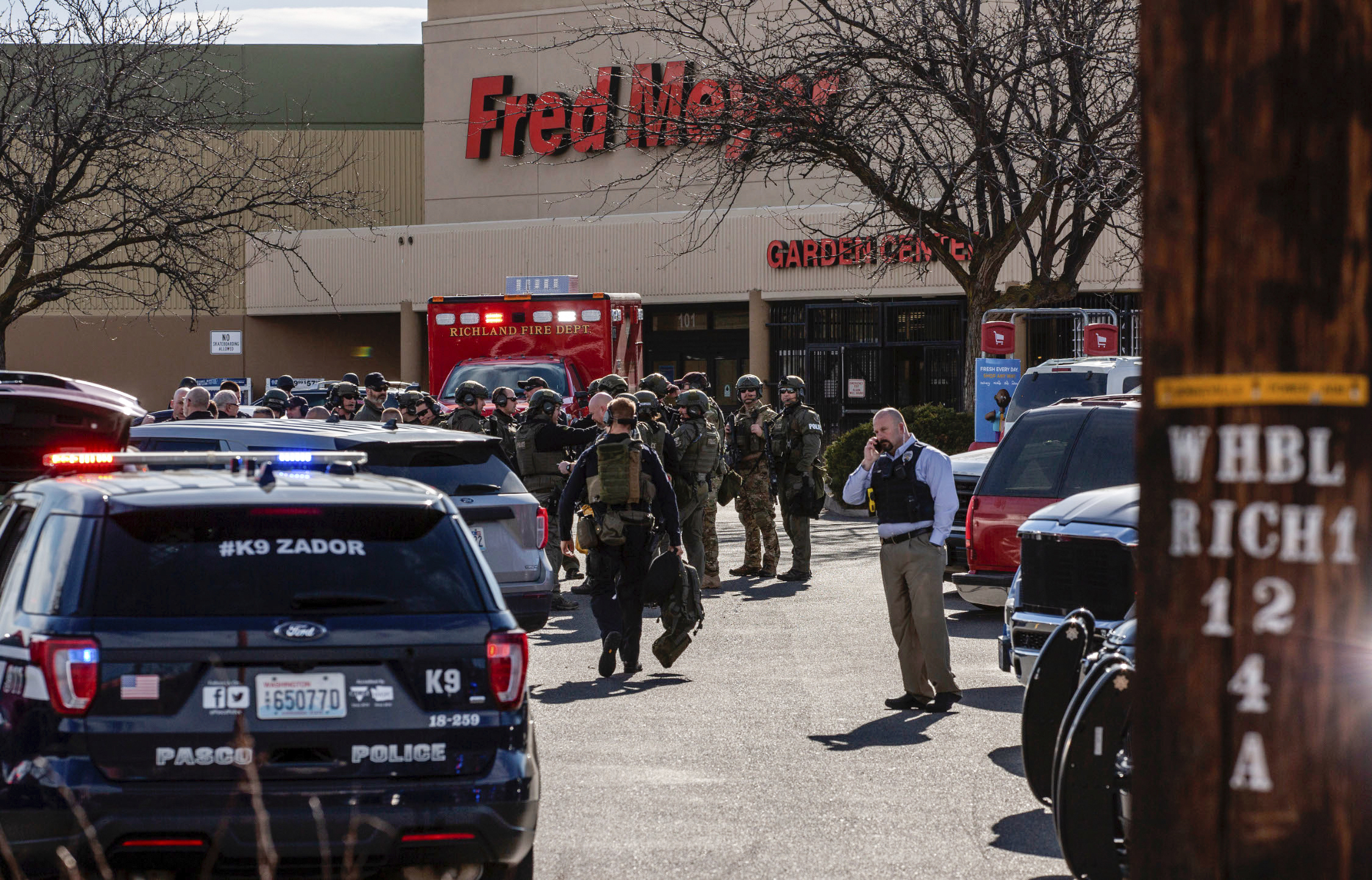 Authorities stage outside a Fred Meyer grocery store after a fatal shooting at the business on Wellsian Way in Richland, Wash., Monday, Feb. 7, 2022. (Jennifer King/The News Tribune via AP)