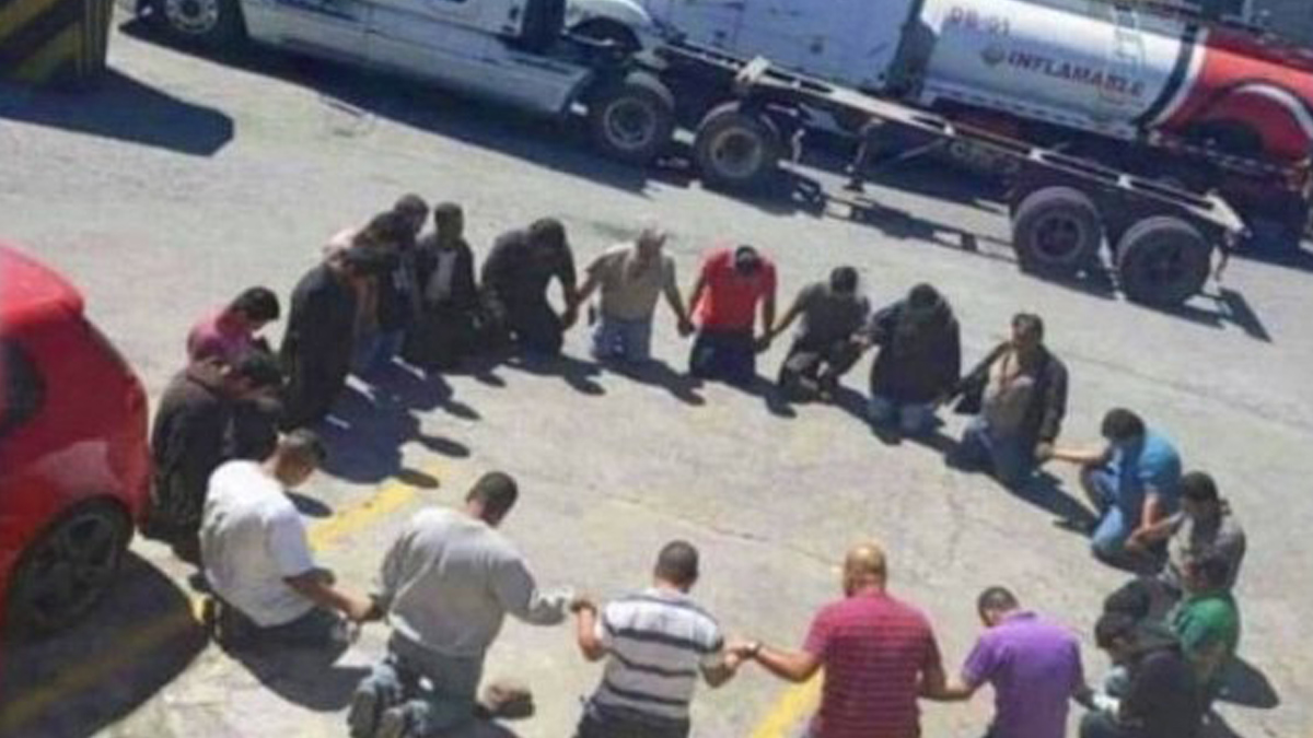 A picture of a trucker prayer circle showed men near trucks praying purportedly near the Canada or Canadian border in 2022 but actually showed Honduras in 2020.