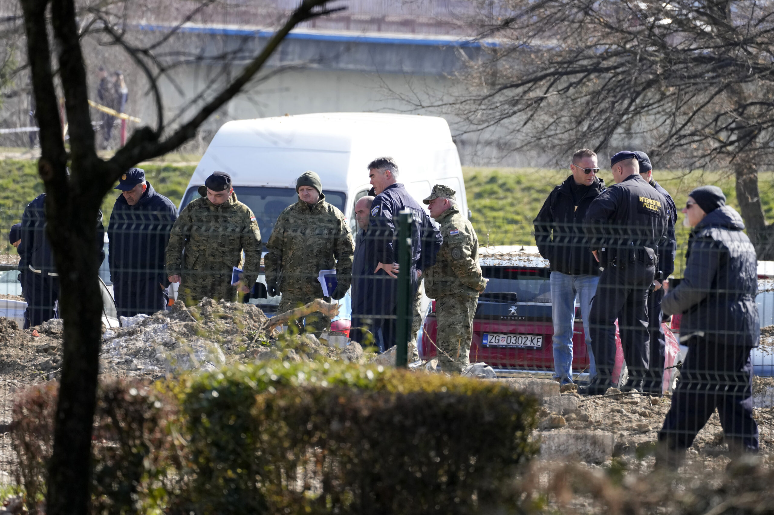 Police inspect site of a drone crash in Zagreb, Croatia, Friday, March 11, 2022. A drone that apparently flew all the way from the Ukrainian war zone crashed overnight on the outskirts of the Croatian capital, Zagreb, triggering a loud blast but causing no injuries, Croatian authorities said Friday. (AP Photo/Darko Bandic)