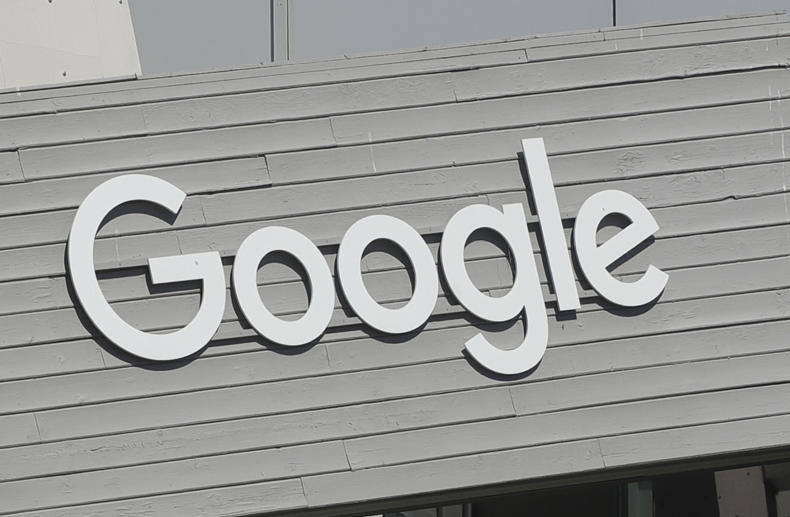 FILE - A Google sign on the is shown on the company campus in Mountain View, Calif., on Sept. 24, 2019. A former Google employee has sued the tech giant saying it engages in a “pattern and practice” of racial discrimination against its Black workers, steering them into lower-level and lower-paid jobs and subjecting them to a hostile work environment if they speak out. (AP Photo/Jeff Chiu, File)