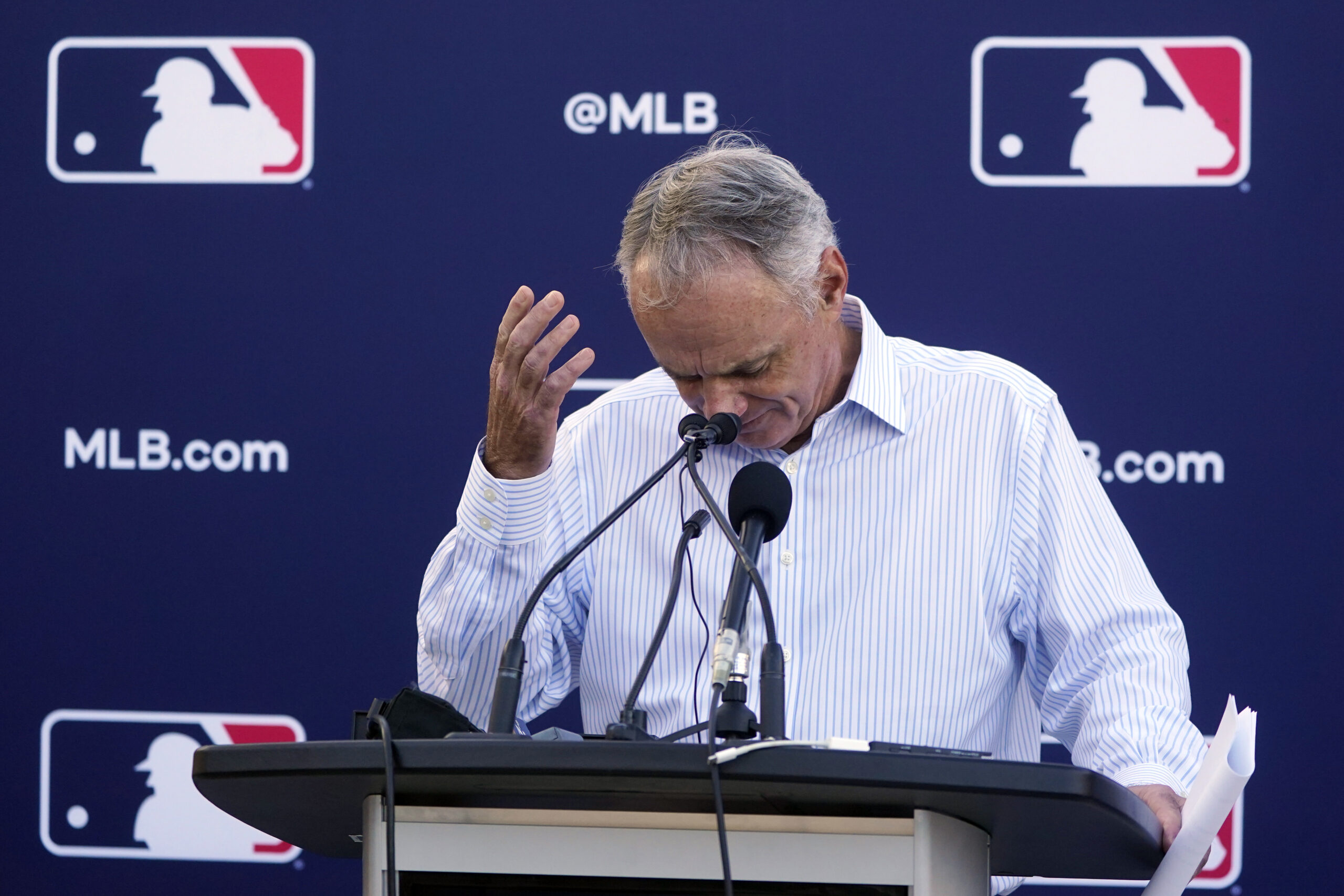 Major League Baseball Commissioner Rob Manfred gestures as he answers questions during a news conference after negotiations with the players' association toward a labor deal, Tuesday, March 1, 2022, at Roger Dean Stadium in Jupiter, Fla. Manfred said he is canceling the first two series of the season that was set to begin March 31, dropping the schedule from 162 games to likely 156 games at most. Manfred said the league and union have not made plans for future negotiations. Players won't be paid for missed games. (AP Photo/Wilfredo Lee)