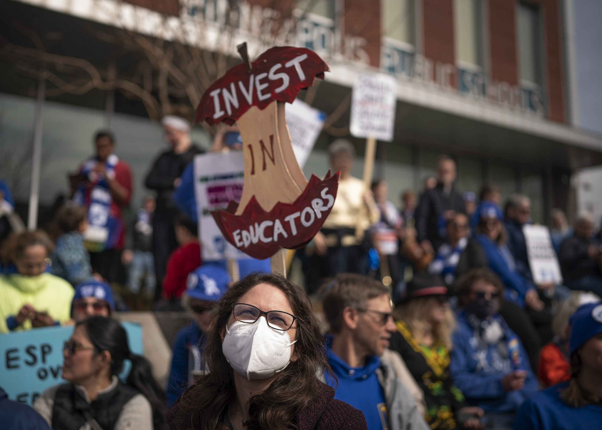 Holly Thorsta, foreground, an art teacher at Roosevelt High, stands in silence with other teachers as Native American leaders honored the land in front of the Davis Center to picket on the 10th day of the teachers strike in Minneapolis, Monday, March 21, 2022. (Jerry Holt/Star Tribune via AP)