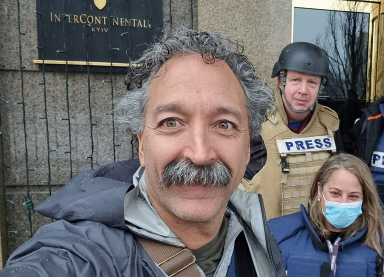 This image released by Fox News Channel shows cameraman Pierre Zakrzewski while on assignment with colleagues, Fox News correspondent Steve Harrigan and Jerusalem-based senior producer Yonat Friling, background right, in Kyiv. Zakrzewski was killed in Ukraine on Monday, March 14, 2022, when the vehicle he was traveling in was struck by incoming fire. Zakrzewski was a veteran war photographer who had covered conflicts in Iraq, Afghanistan and Syria for Fox. (Pierre Zakrzewski/Fox News via AP)